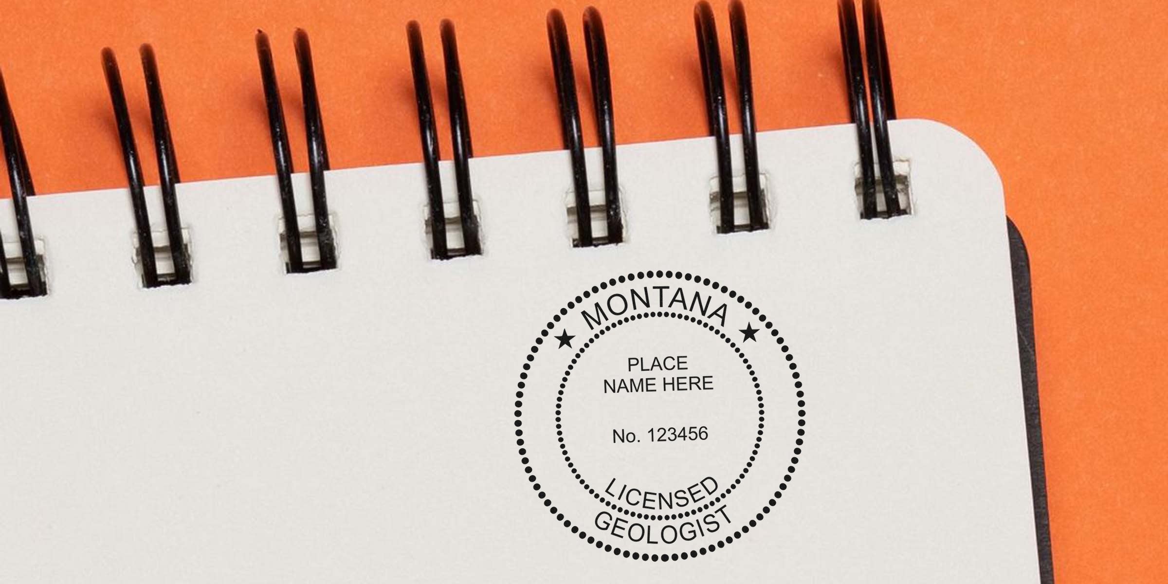 Montana Geologist Stamp on spiral notebook with orange background showcasing Geologist Certification Benefits.