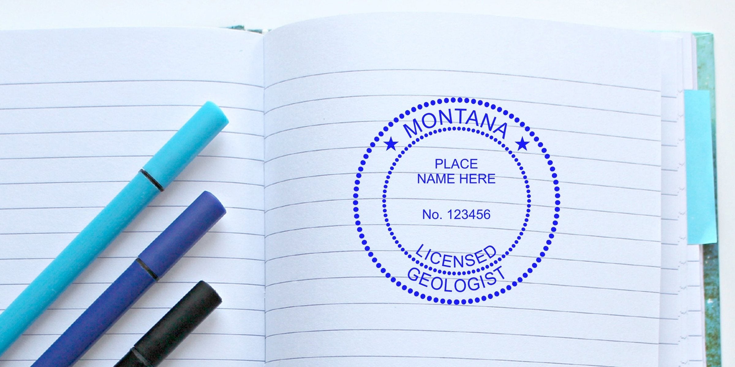 Montana licensed geologist stamp on open notebook with blue pens, showcasing geologist stamp collectibles and mineral-themed postage stamps.