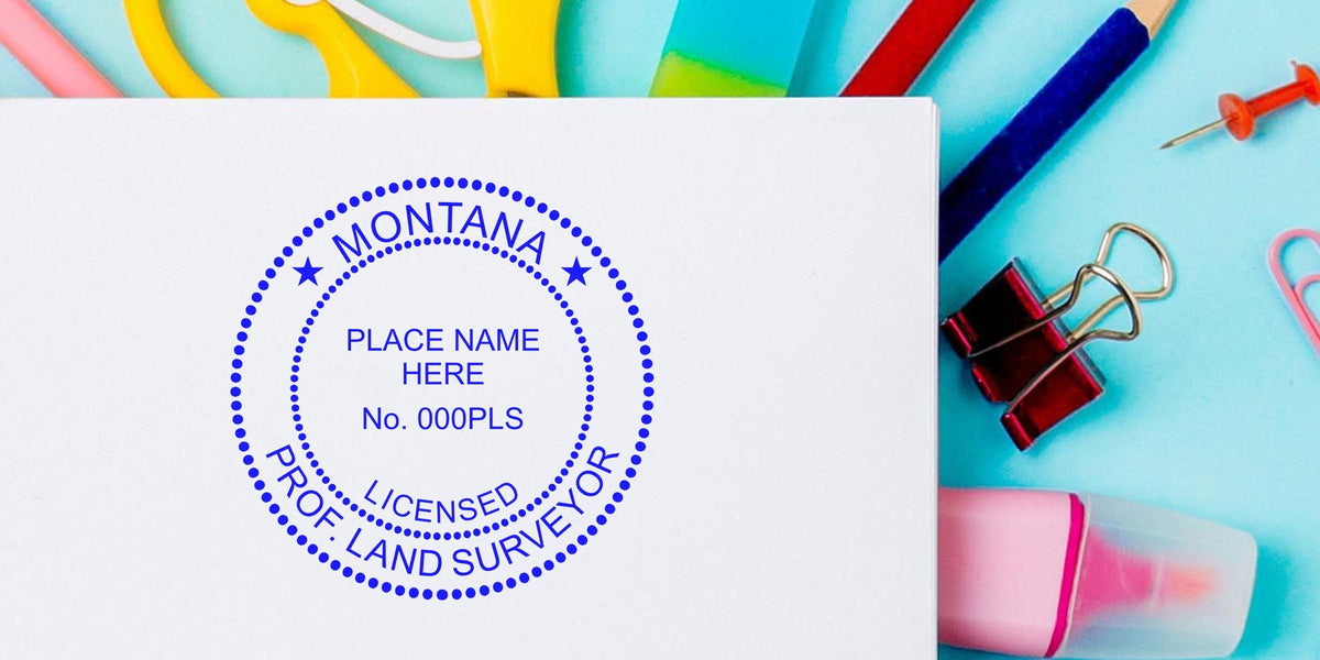 Montana licensed land surveyor stamp on white paper with office supplies, highlighting Montana land surveyor fees and stamp costs.