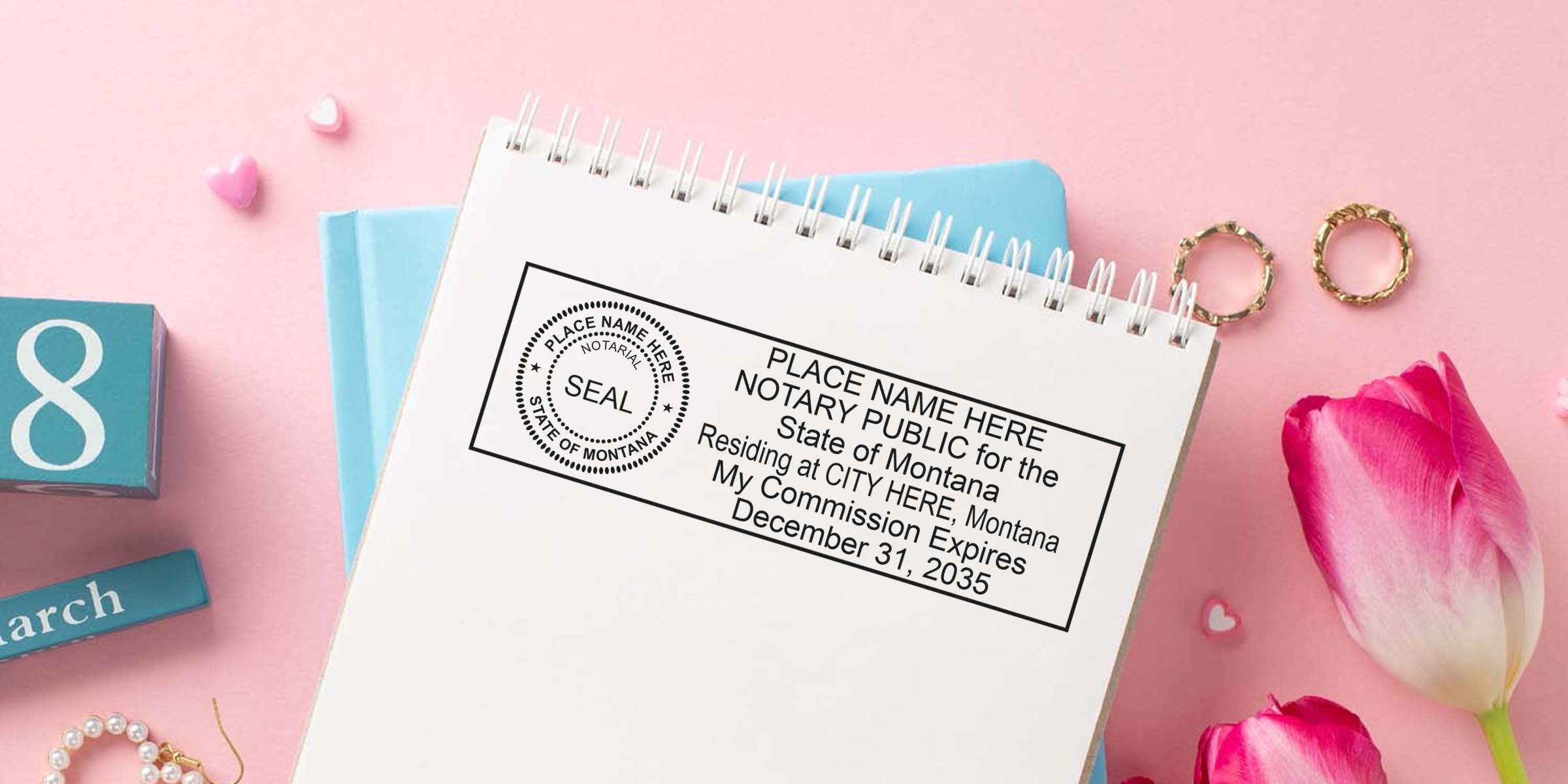 Montana notary public stamp on notebook with March calendar and pink tulips, highlighting the commission expiration date.
