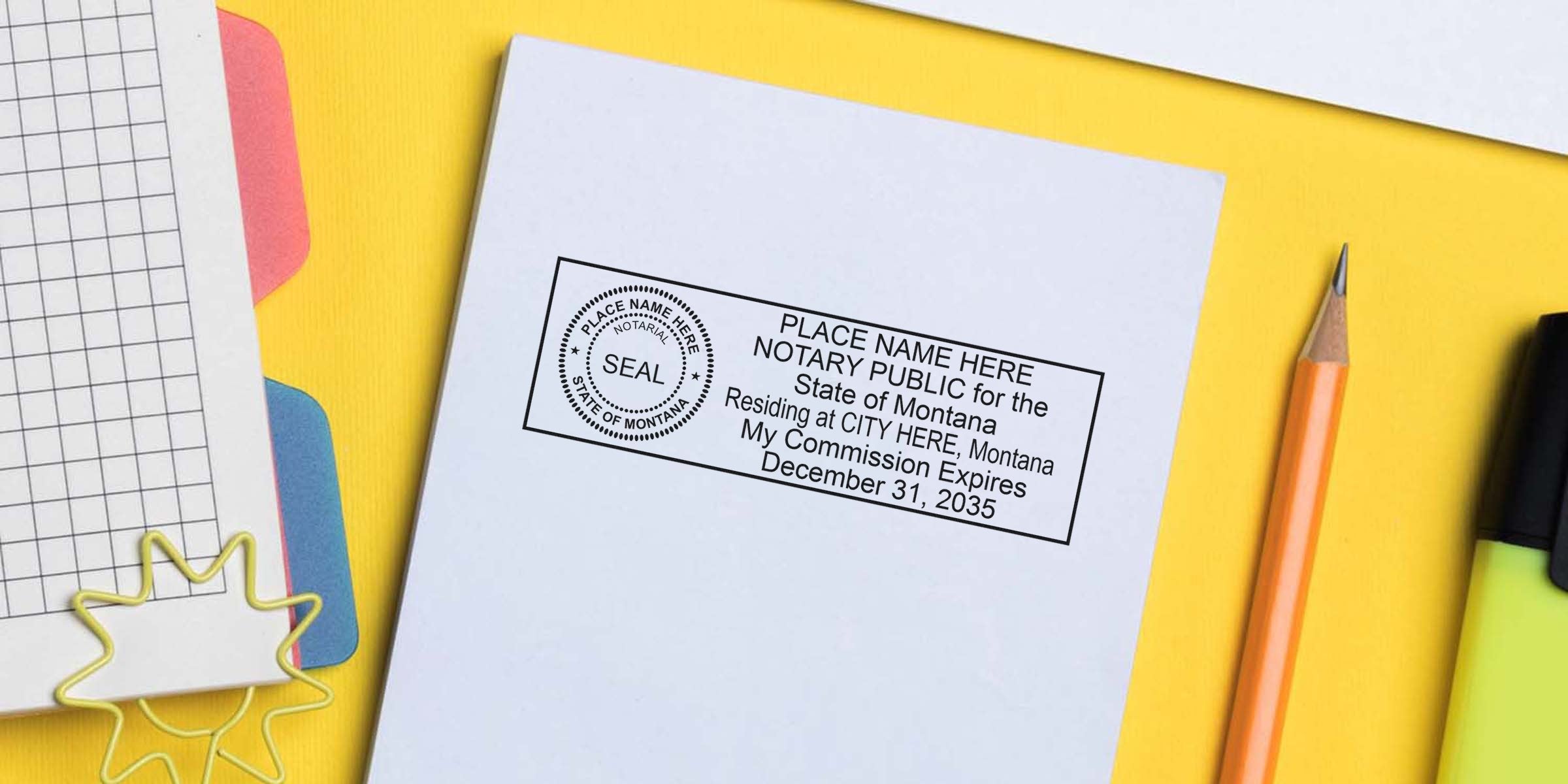 Montana notary stamp on white paper with pencil and office supplies on yellow background, meeting Montana notary stamp requirements.
