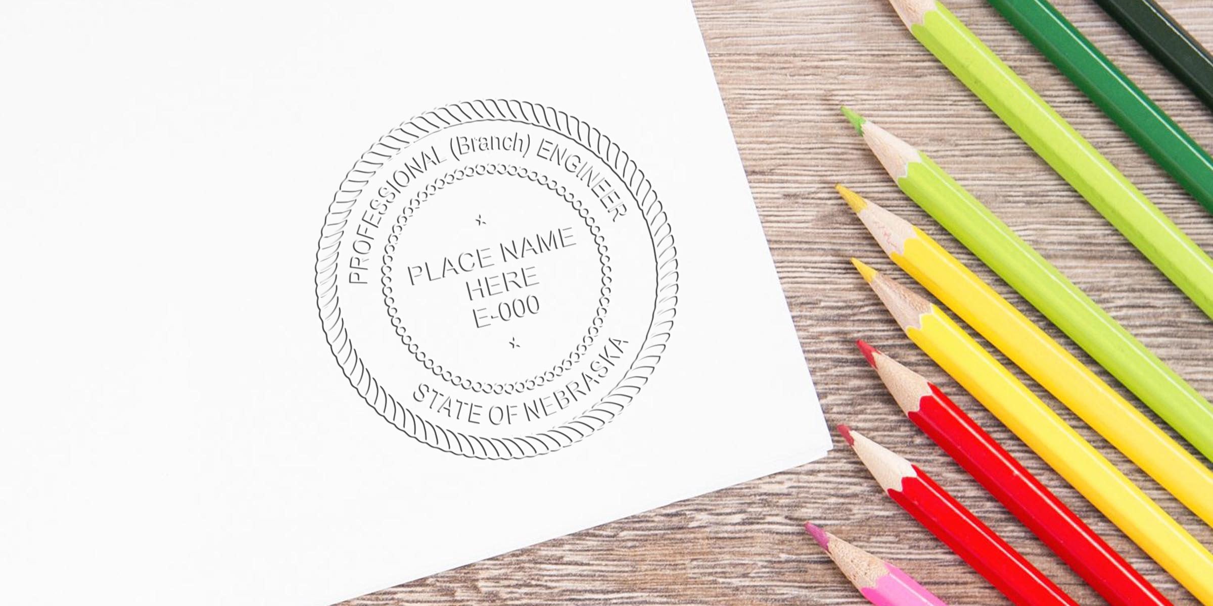 Nebraska engineer stamp on white paper with colored pencils on wooden table, showing professional engineer seal and stamp requirements.