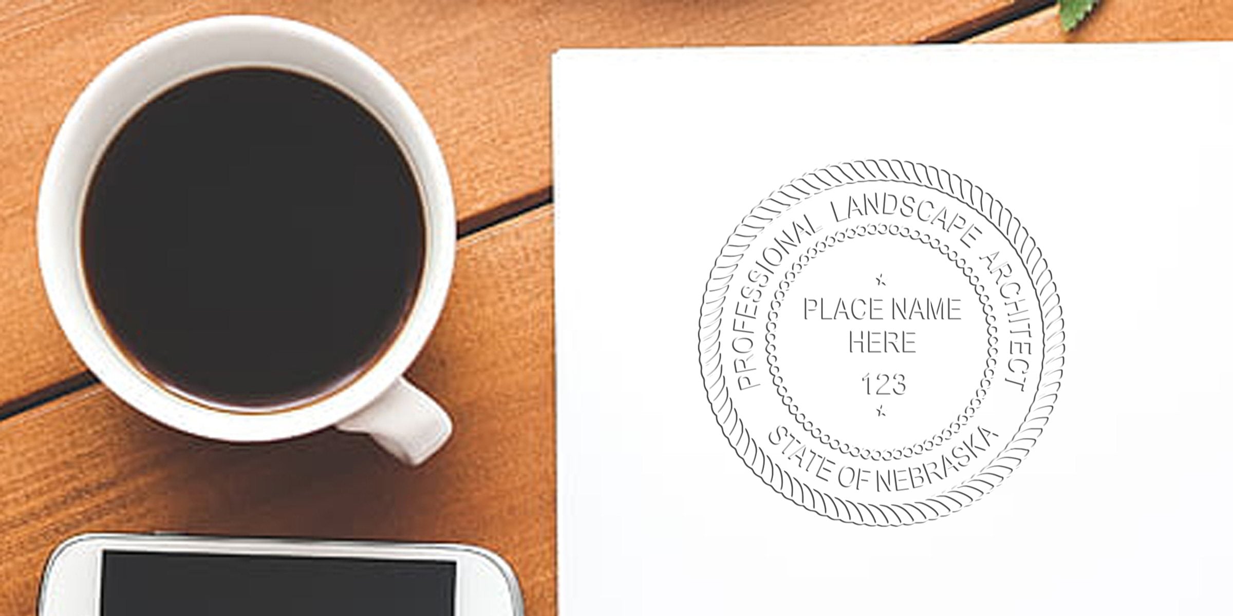 Nebraska landscape architect stamp on white paper next to coffee cup and smartphone on wooden table, with tips for buying a landscape architect stamp.