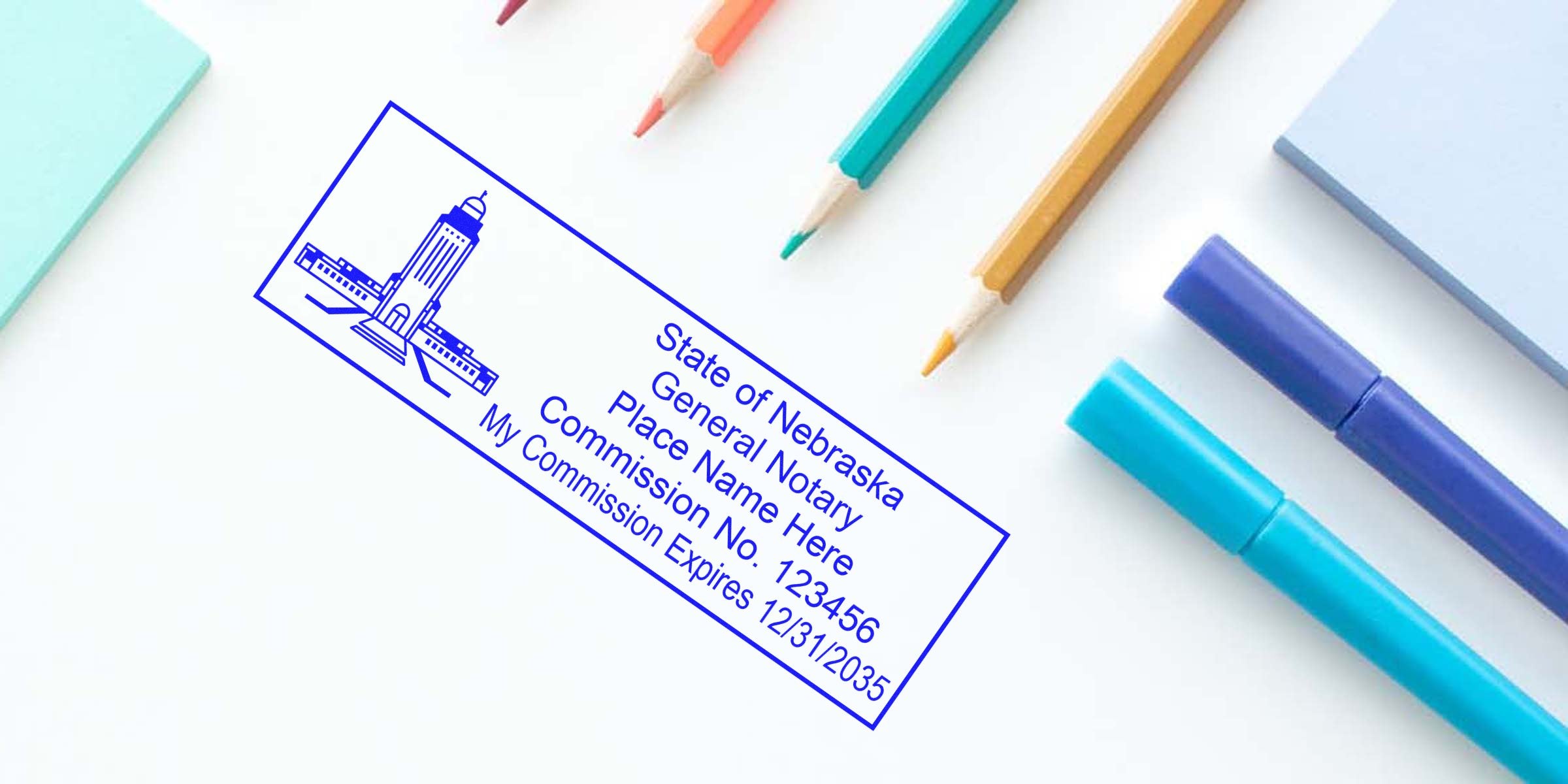 Nebraska general notary stamp with commission number and seal expiration on white desk, alongside colored pencils and markers, used to verify Nebraska notary seal.