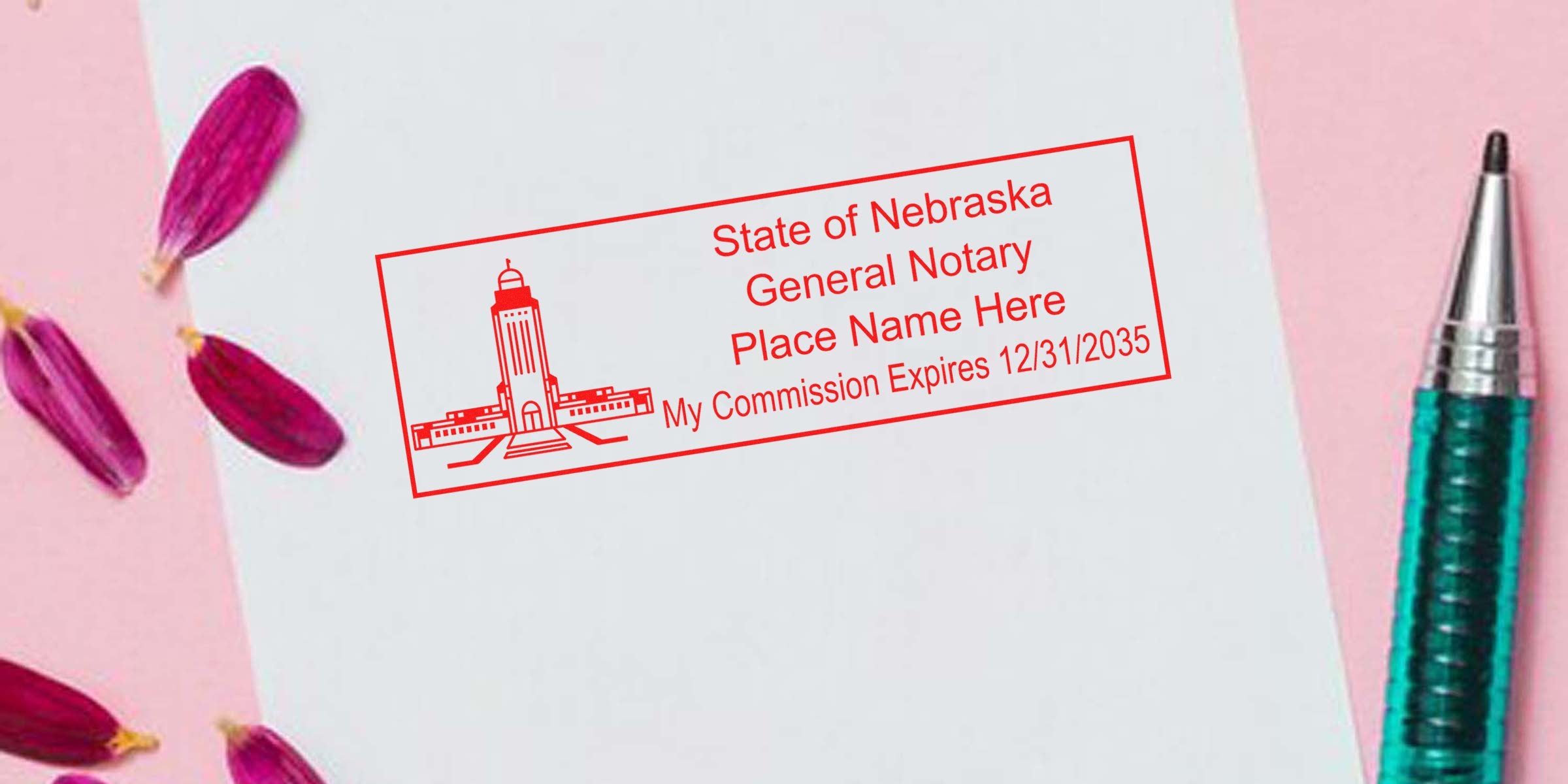 Nebraska notary seal on white paper with commission expiration date and pen, showing notary seal application in Nebraska.