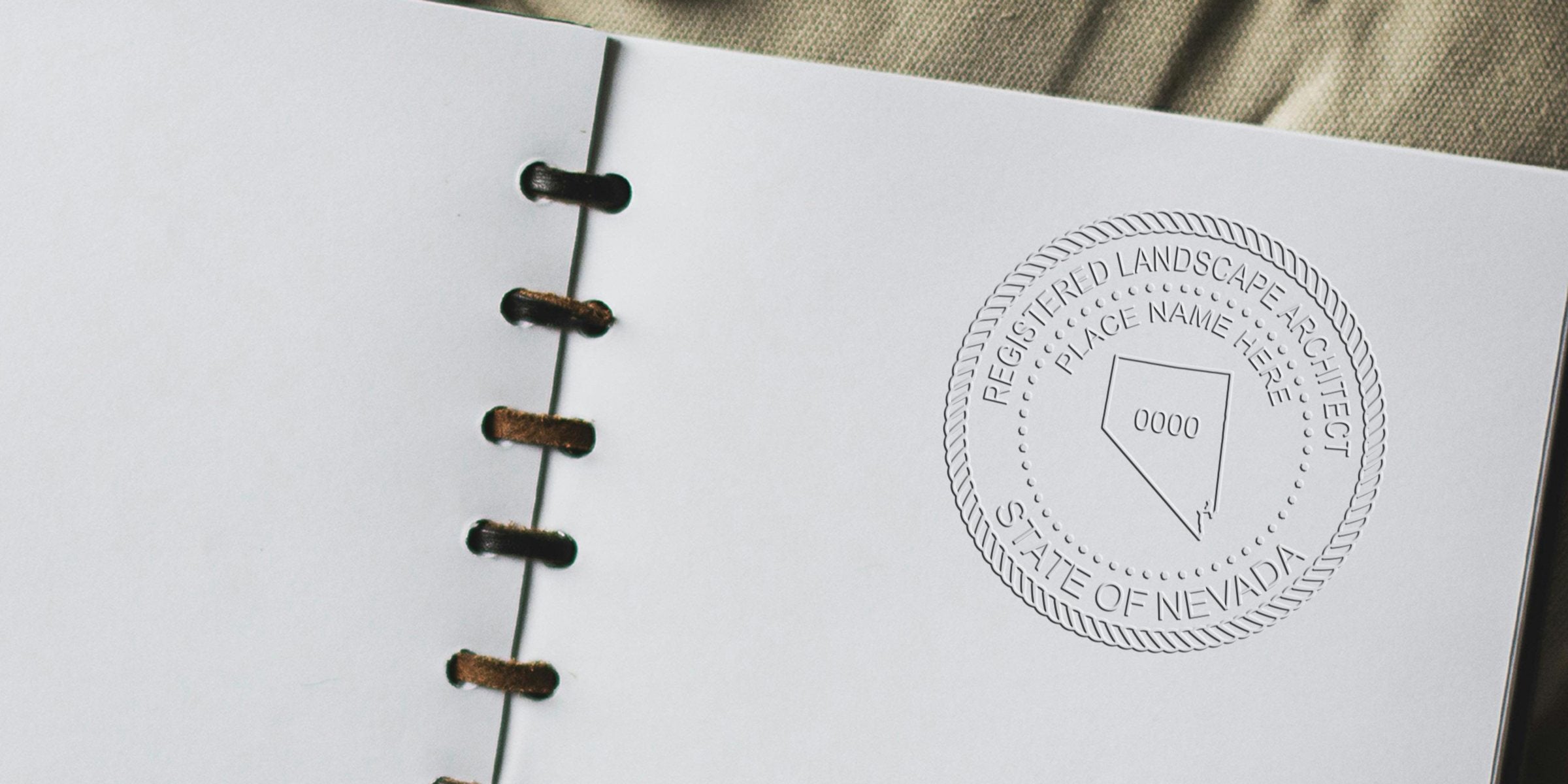 Embossed Nevada landscape architect stamp on white notebook, featuring a registered landscape architect seal for state license verification.