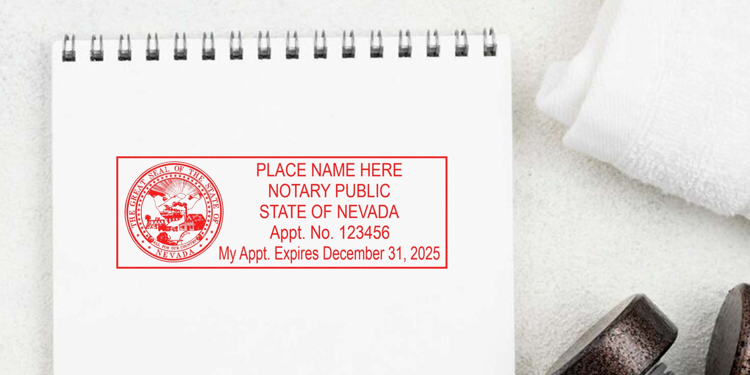 Nevada notary public stamp with state seal and appointment expiry on white notepad, showing key Nevada notary supplies and essentials.