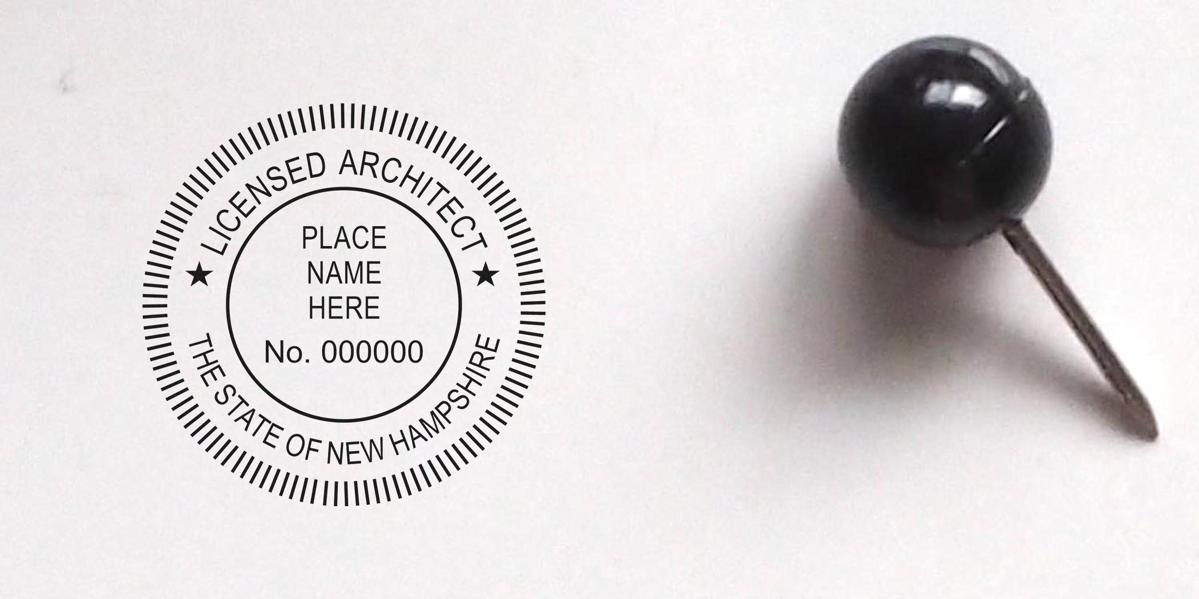 New Hampshire architect license stamp with seal, pinned by black push pin on white background.