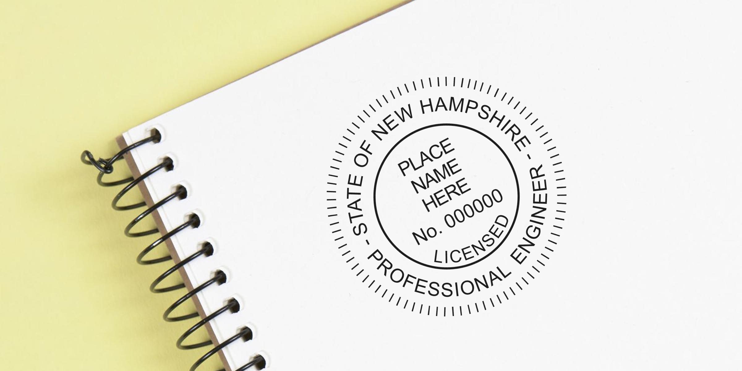 White spiral notebook with New Hampshire PE Stamp and professional engineer seal, adhering to PE Stamp Guidelines.