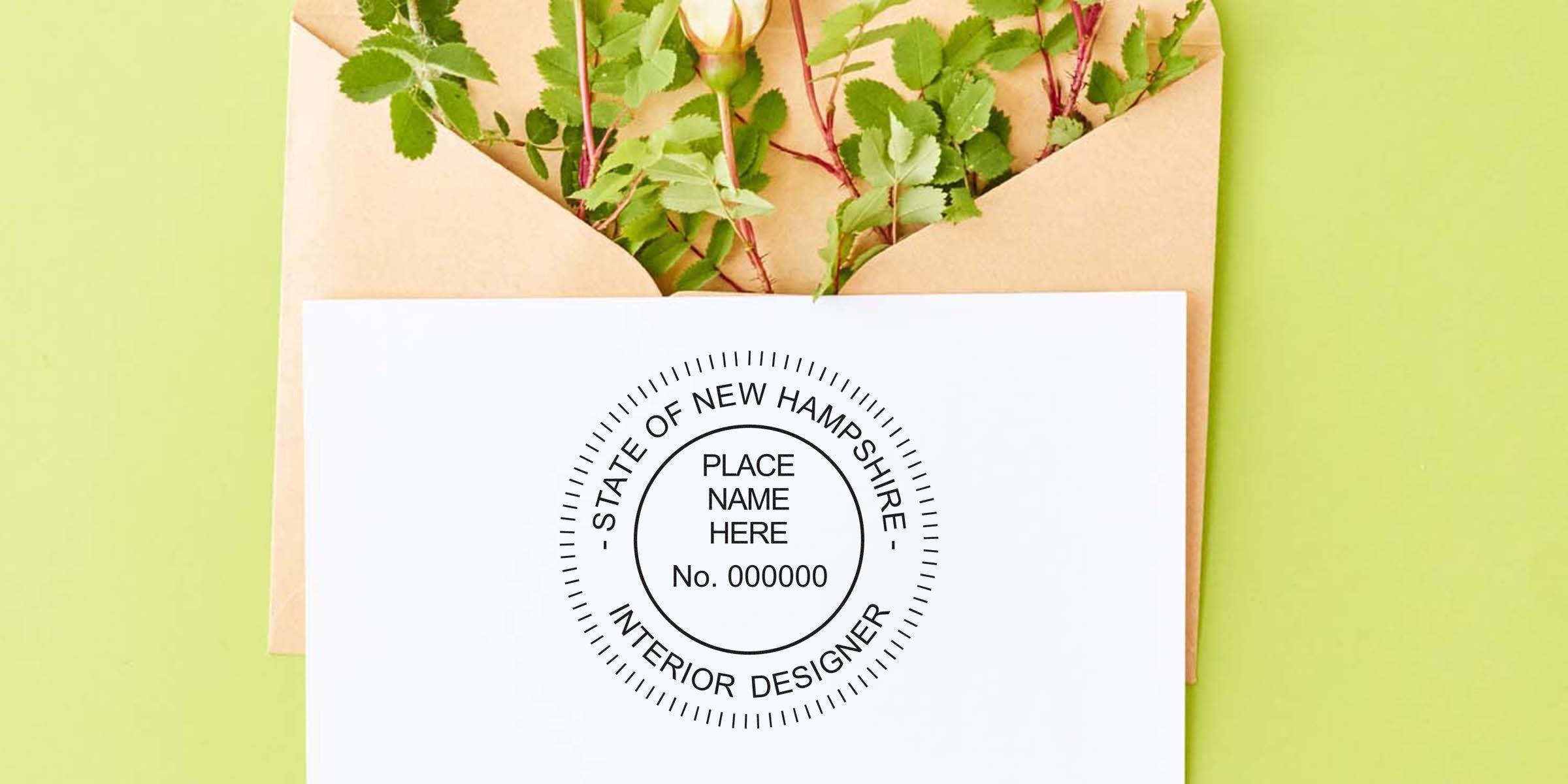 New Hampshire interior designer stamp on white paper with brown envelope and green leaves background, showing interior designer stamp use.