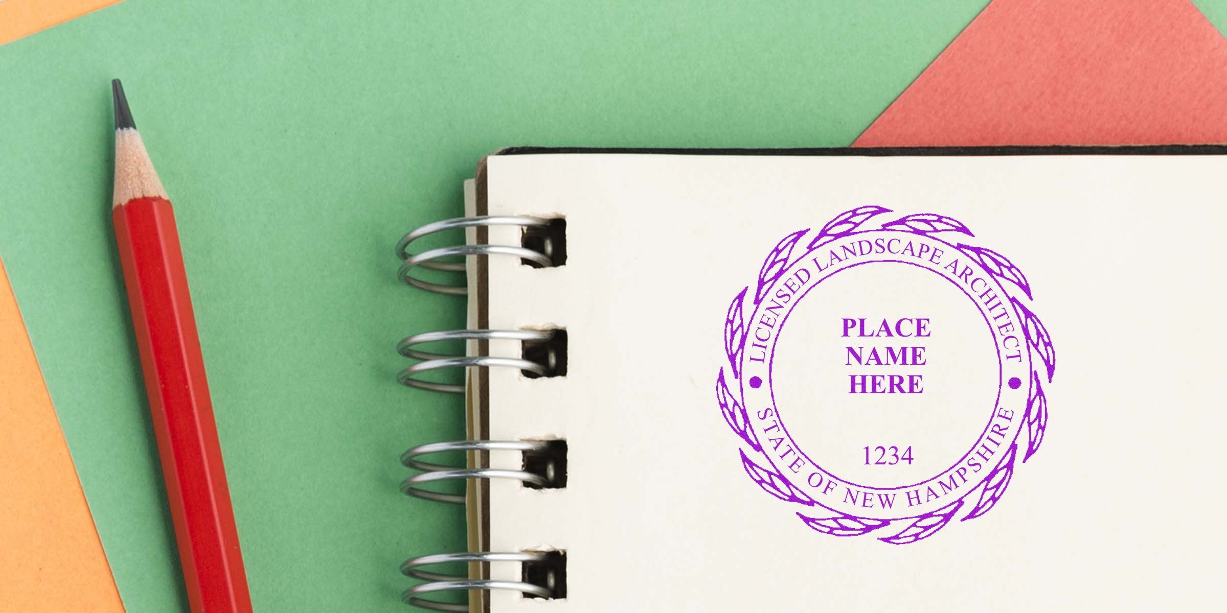 New Hampshire landscape architect stamp on notebook with red pencil, highlighting NH landscape architect stamp requirements.