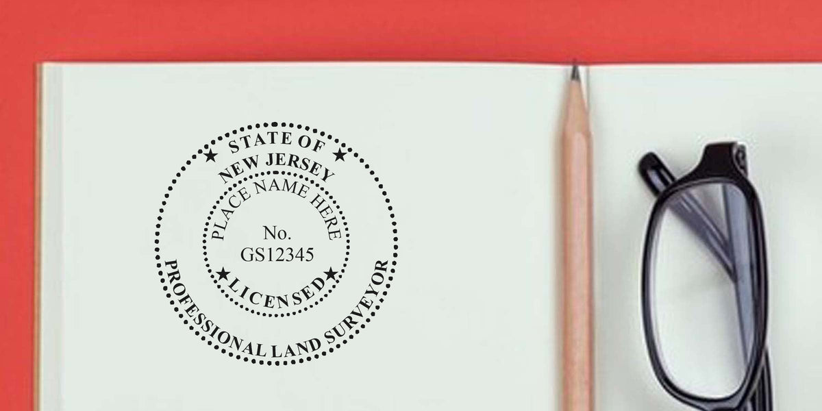 New Jersey land surveyor stamp with pencil and glasses on a notebook, demonstrating how to purchase a land surveyor stamp online.