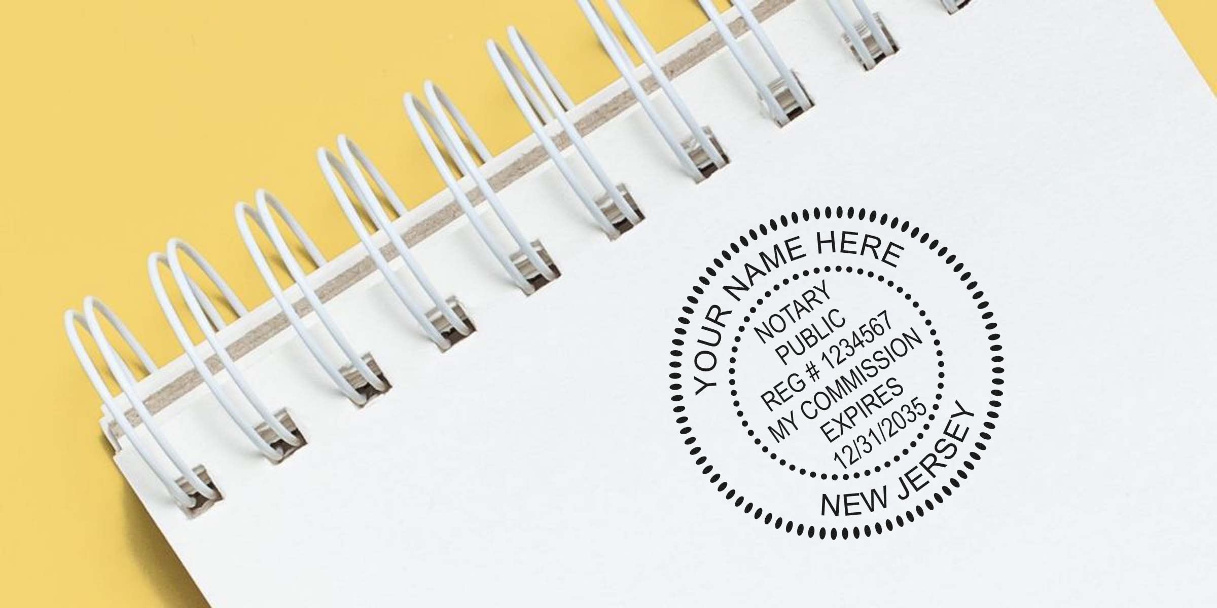 New Jersey notary stamp with official seal on white spiral notebook against yellow background.