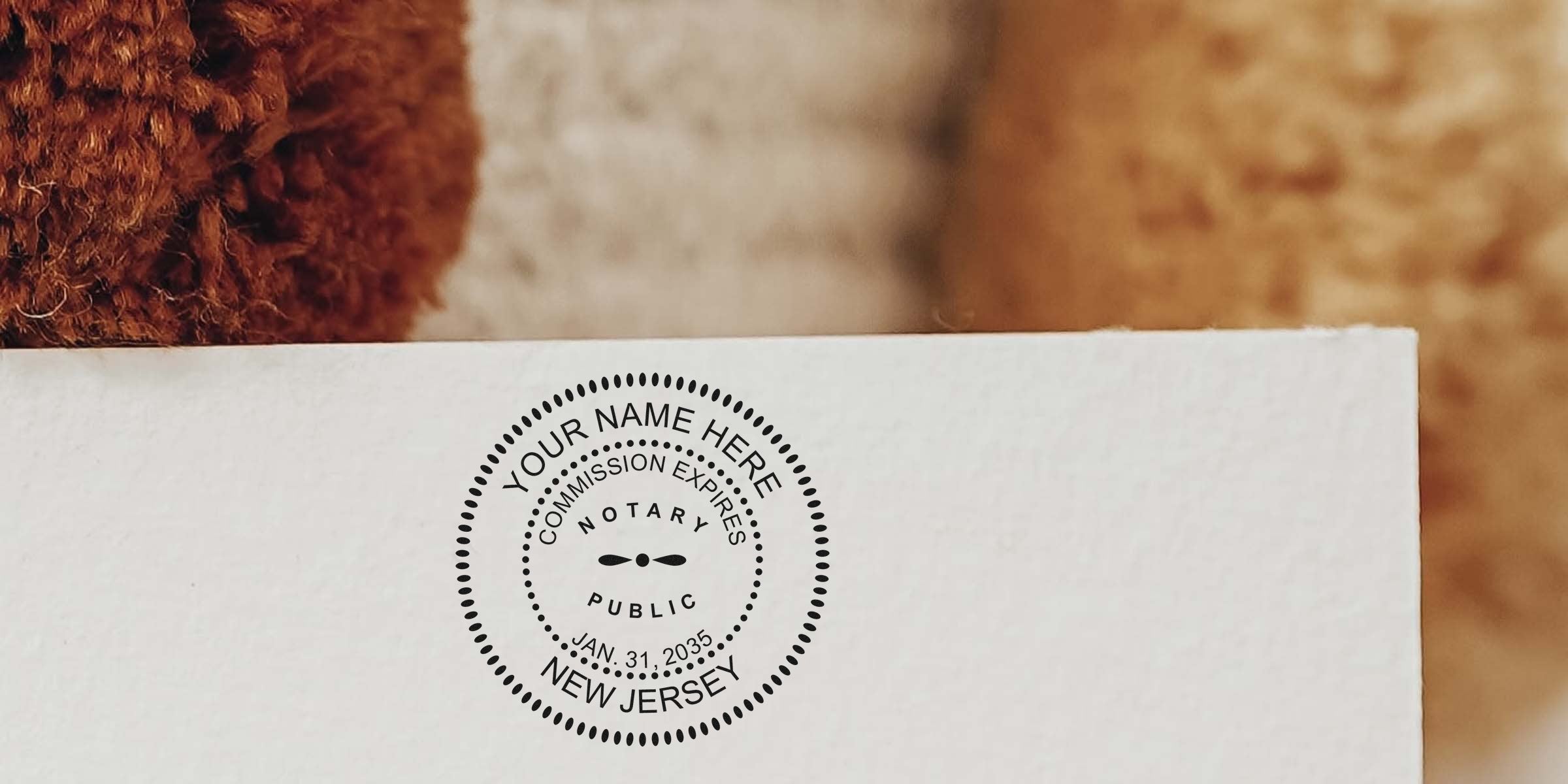 Custom New Jersey notary seal stamp on white paper with commission expiration date, ideal for NJ notary stamp orders.
