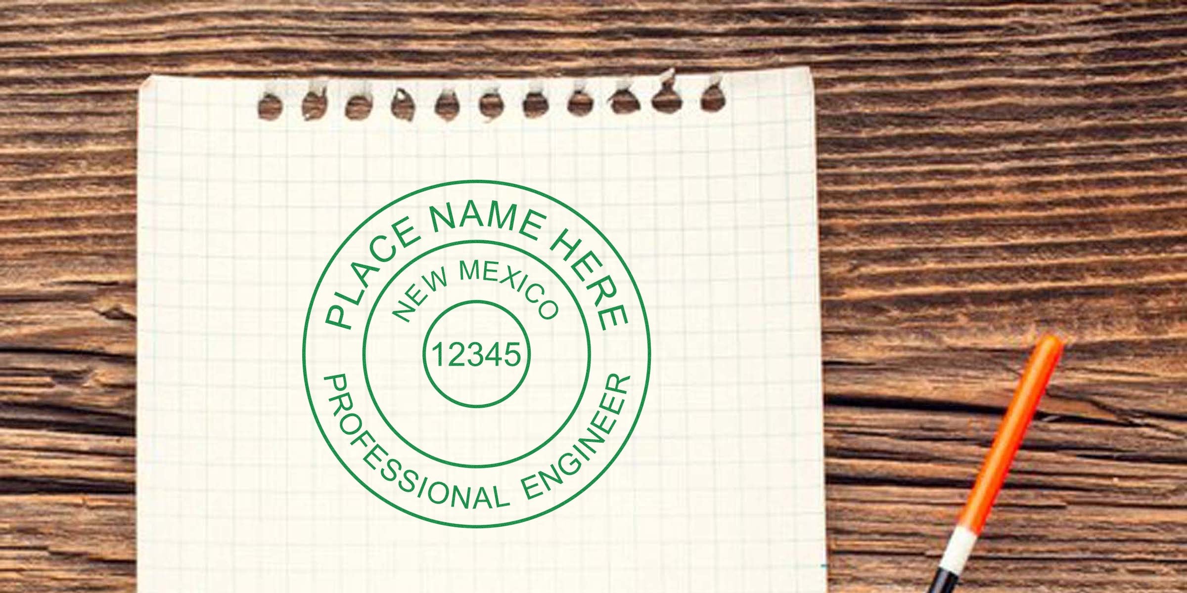 Engineer Stamp New Mexico on graph paper with orange pen on wooden desk, ideal for anyone wanting to buy Engineer Stamp NM.