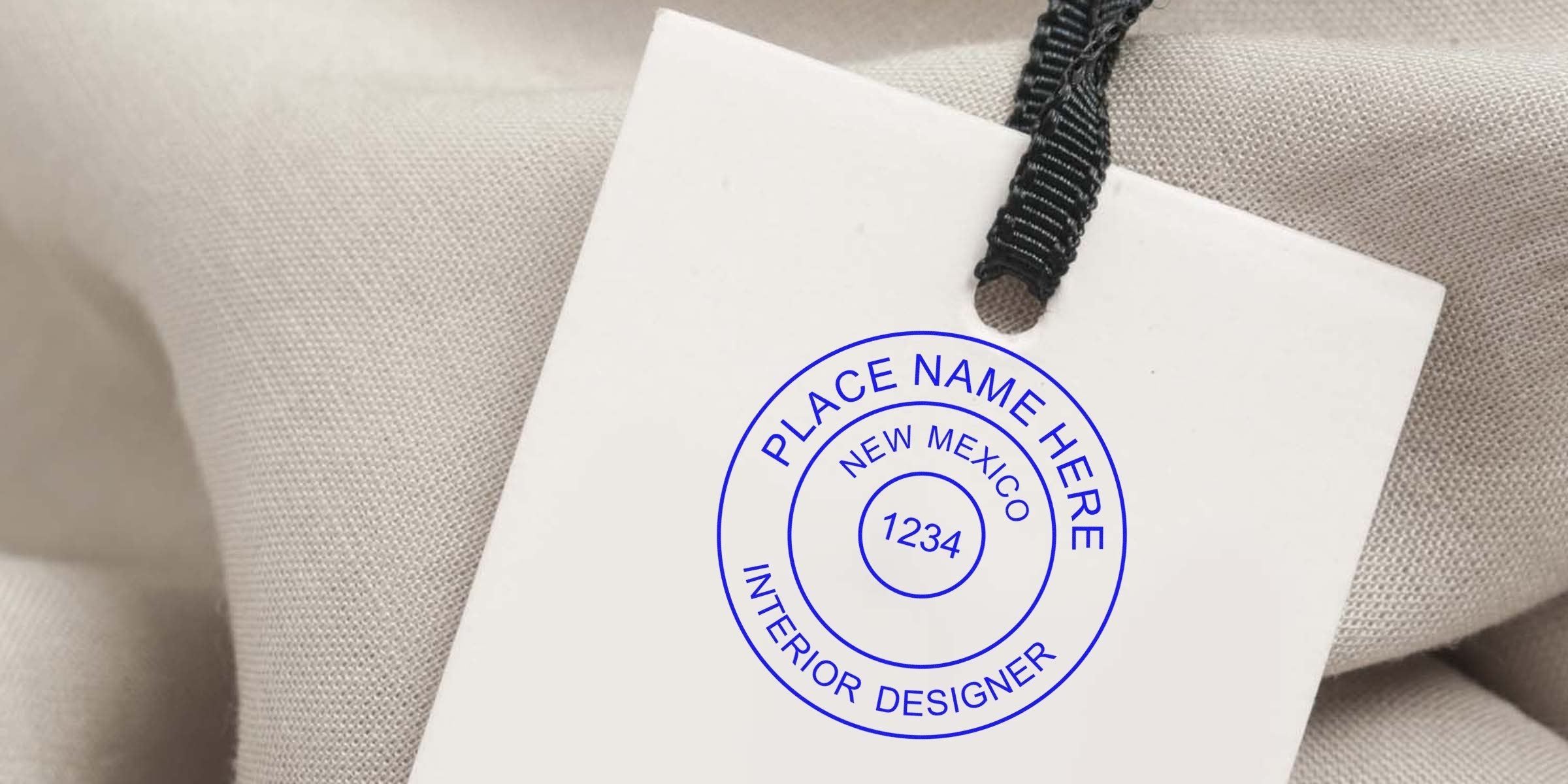 Custom interior designer label tag with New Mexico design and designer stamps on beige fabric background.