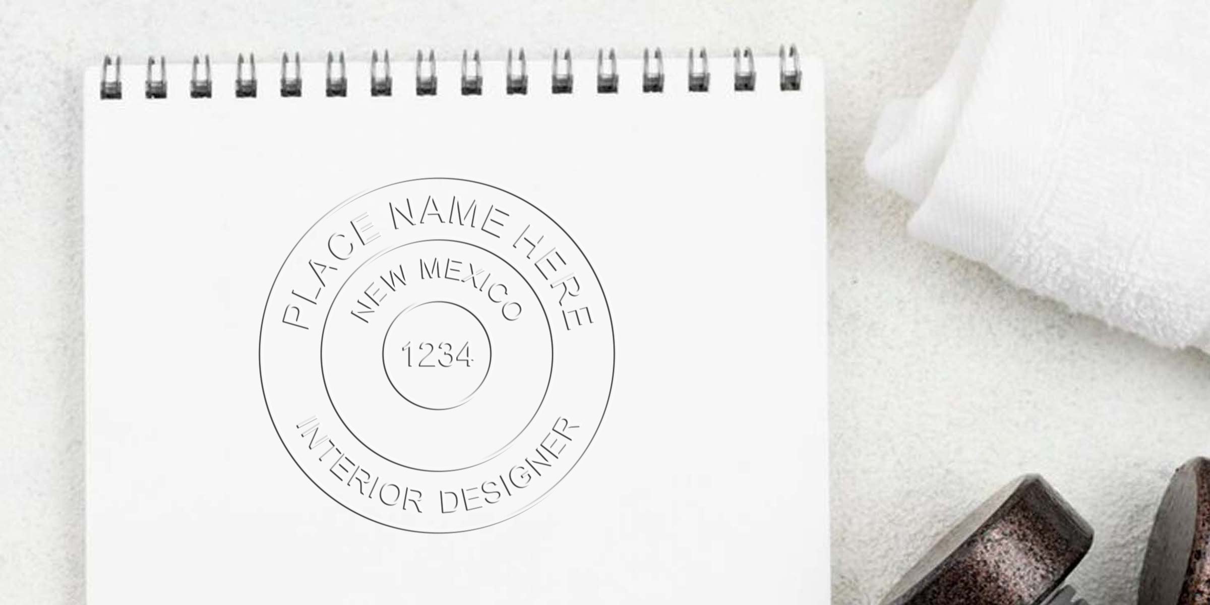 Custom rubber stamp for New Mexico interior design with place name and number 1234 on white notepad, perfect for interior designers.