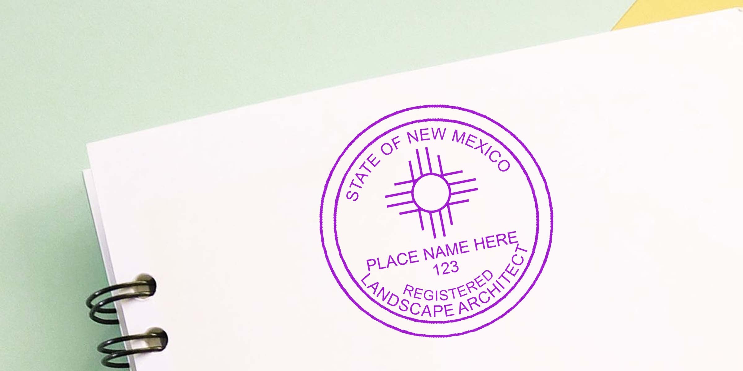 New Mexico landscape architect stamp on white spiral notebook, meeting certification verification guidelines.