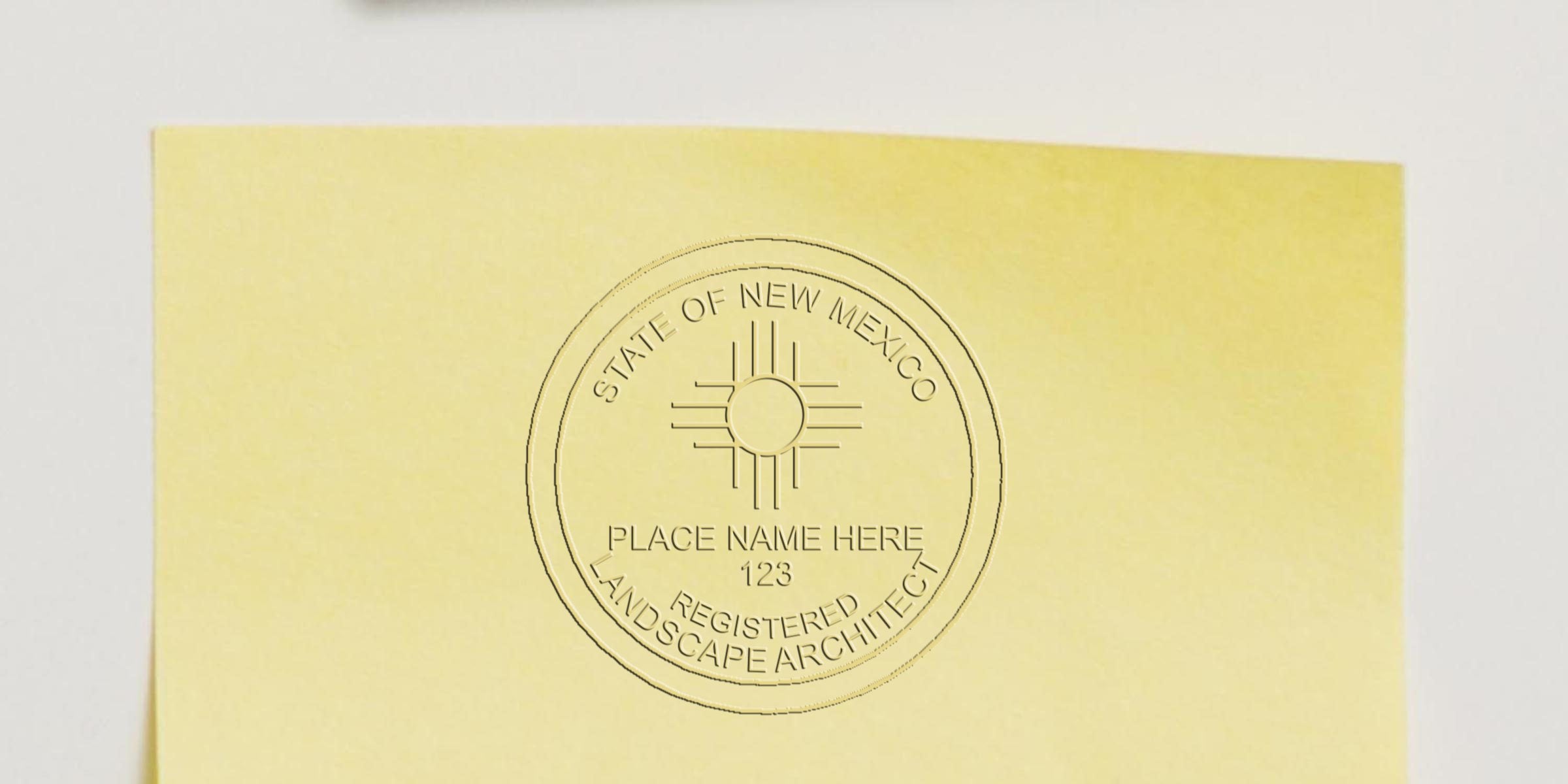 Embossed New Mexico registered landscape architect seal on yellow paper with custom place name and number, showing NM stamp requirements and stamp tax rules.