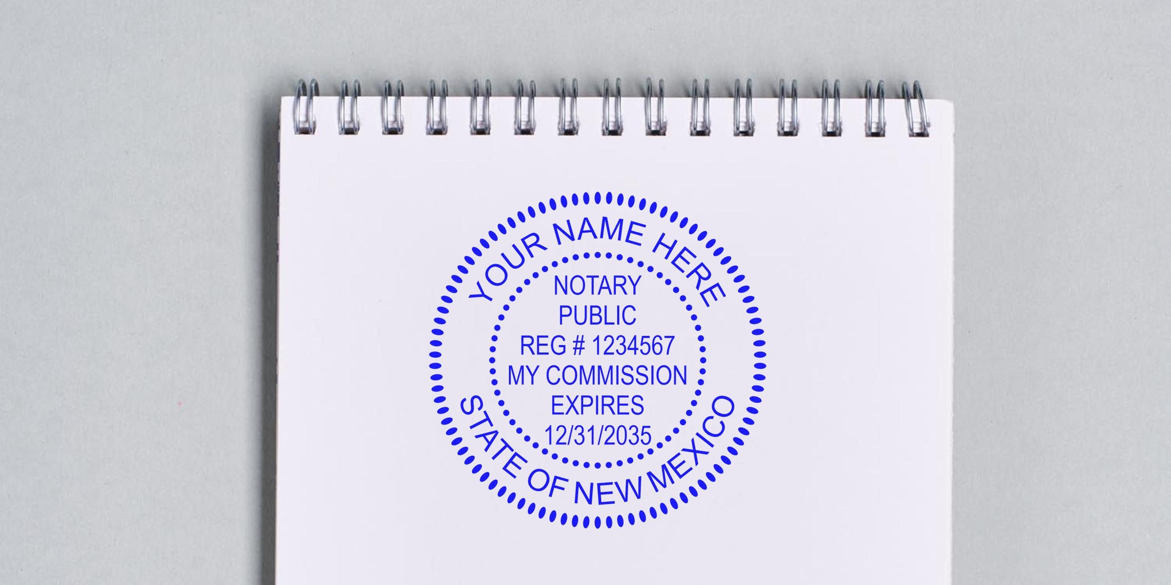 New Mexico notary public stamp with NM seal and commission expiration date on white spiral notebook, highlighting a top notary seal choice.