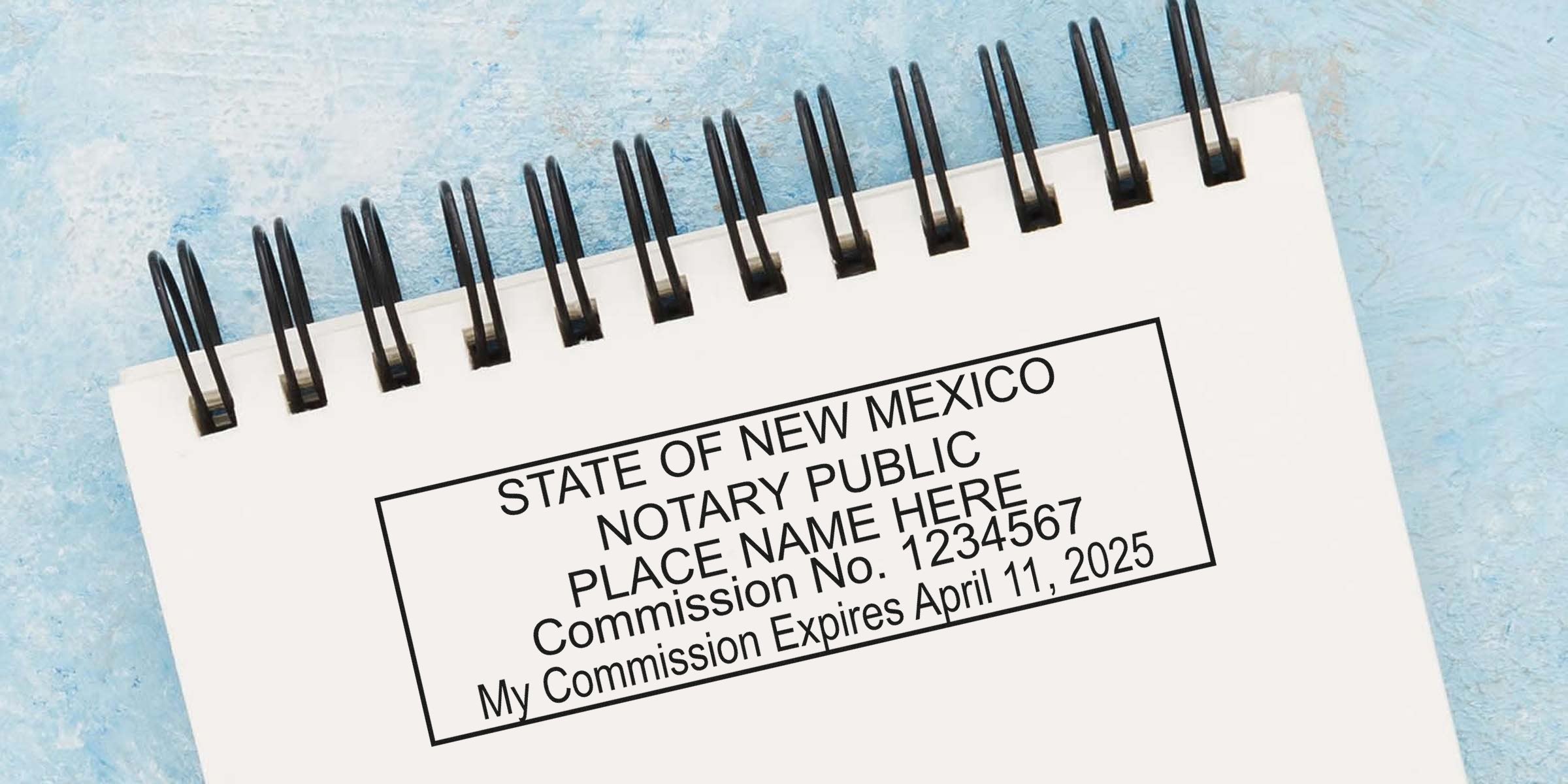 New Mexico notary stamp with official seal, commission number, and expiration date on a spiral notebook.