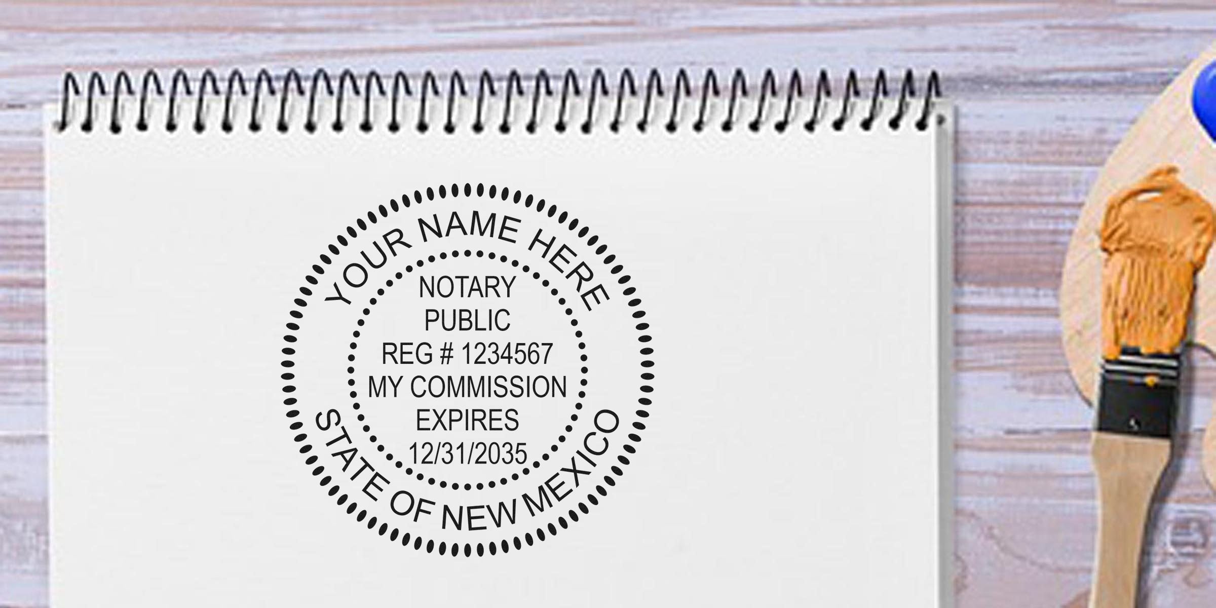 Custom New Mexico notary stamp design on white spiral notebook with paintbrush and palette. Personalized notary public seal for New Mexico commission expiration. Buy your notary stamp today.