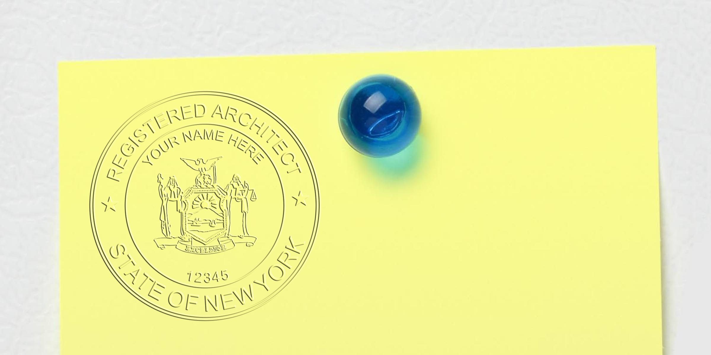 New York architect seal pinned on yellow paper with a blue pushpin, displaying an architect stamp replacement.