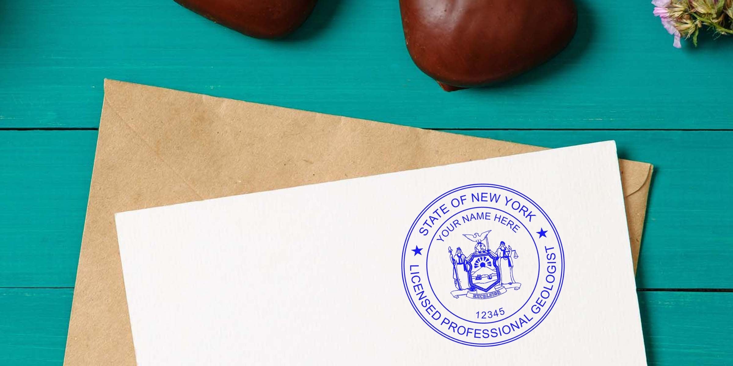 New York Geologist Seal certification stamp on white paper with envelope and decorative hearts on a turquoise wooden background, showing Geologist License NY.