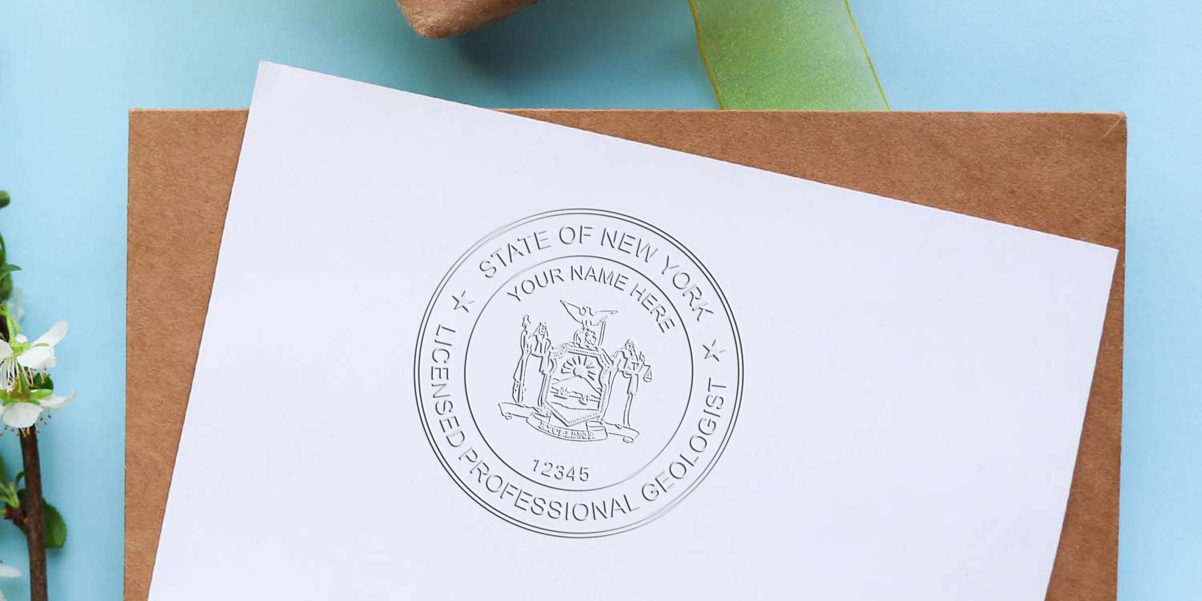 New York Geologist Stamp embossed on white paper, paired with a brown envelope and green ribbon—a unique geological collectible.
