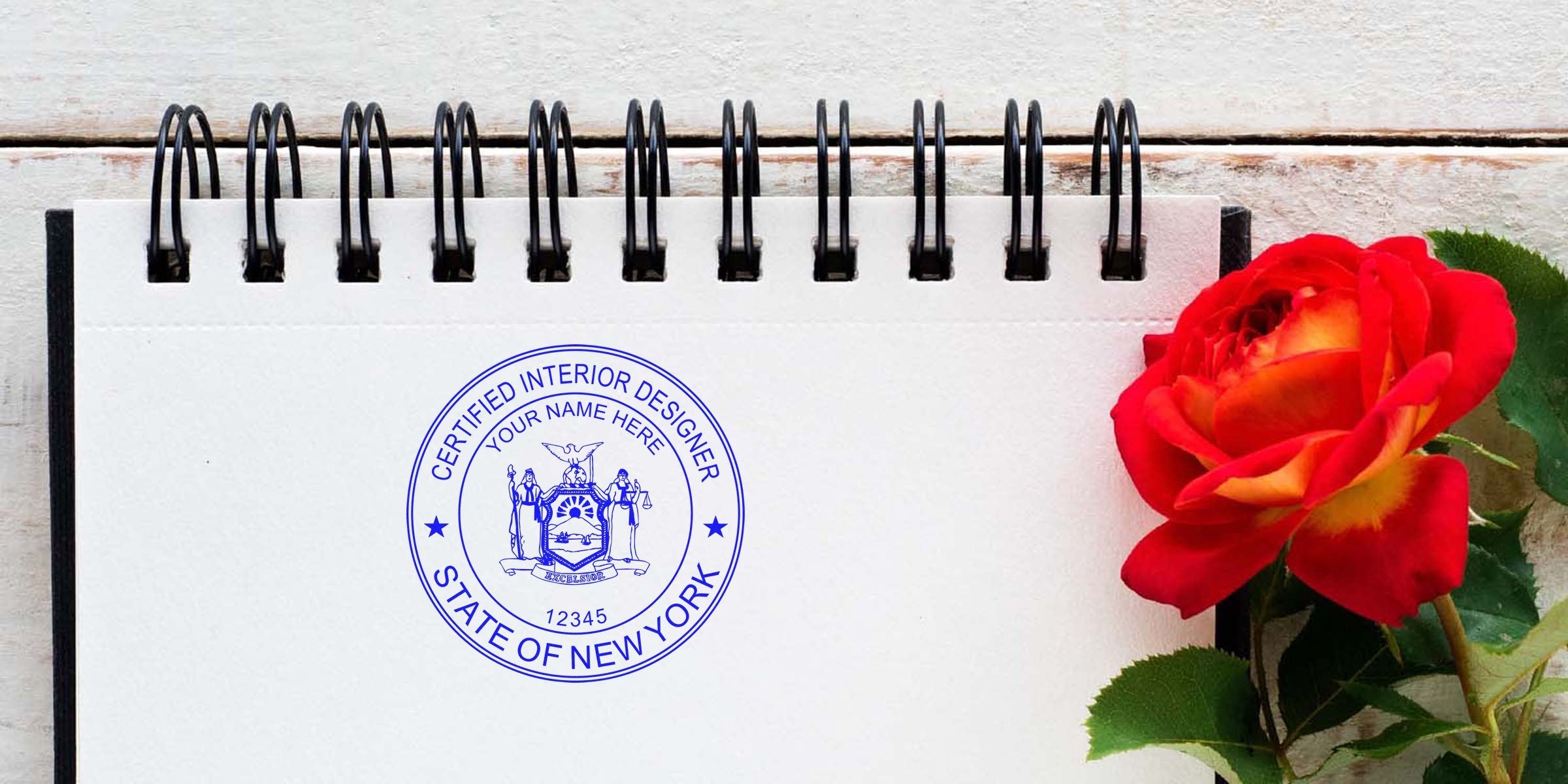 Certified interior designer New York stamp on notebook with red rose, showcasing interior designer New York and online designer stamp.