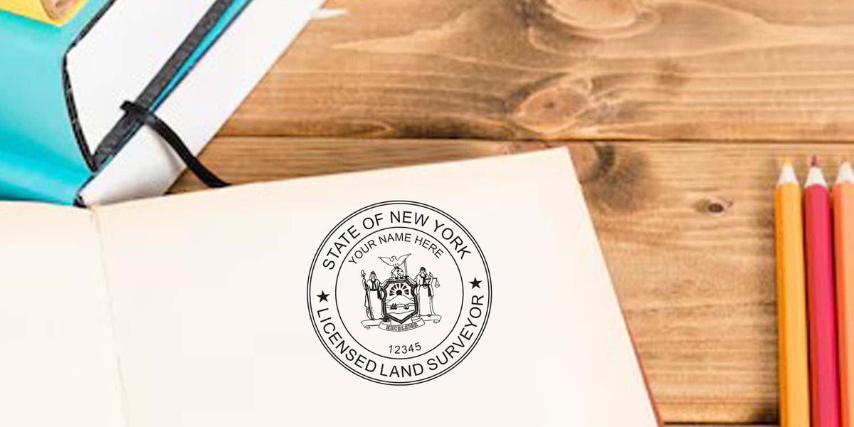 New York land surveyor stamp on notebook with colored pencils and planner on wooden desk, showing State of New York licensed land surveyor seal, ideal for land surveyor stamp buying guide.
