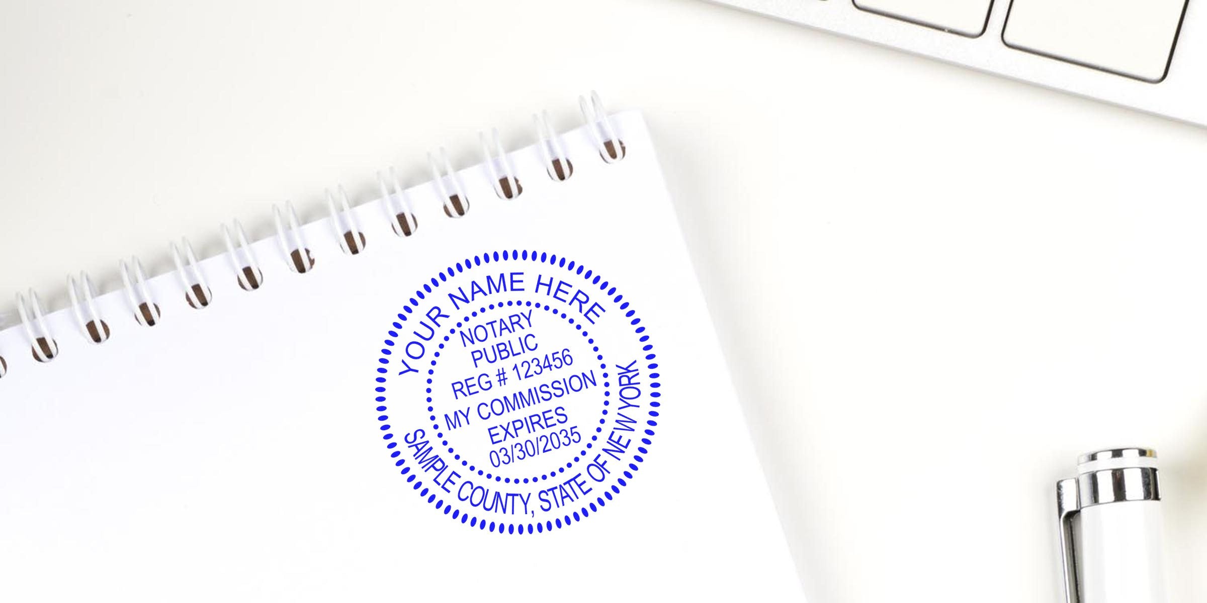 New York notary stamp on white spiral notebook with registration number and commission expiry date, displaying official design for legal document certification.