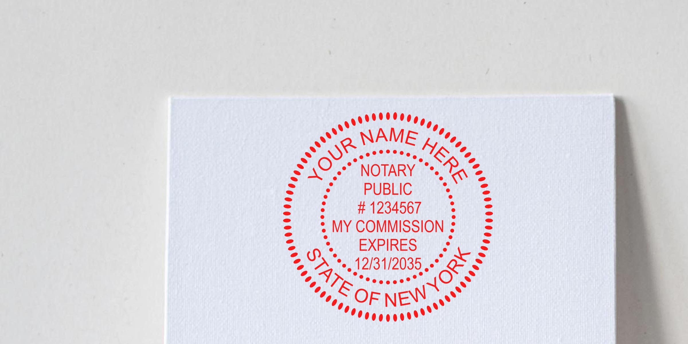 Red New York notary stamp on white paper with official state seal and commission expiration, personalized for legal documents; part of a notary stamp guide.