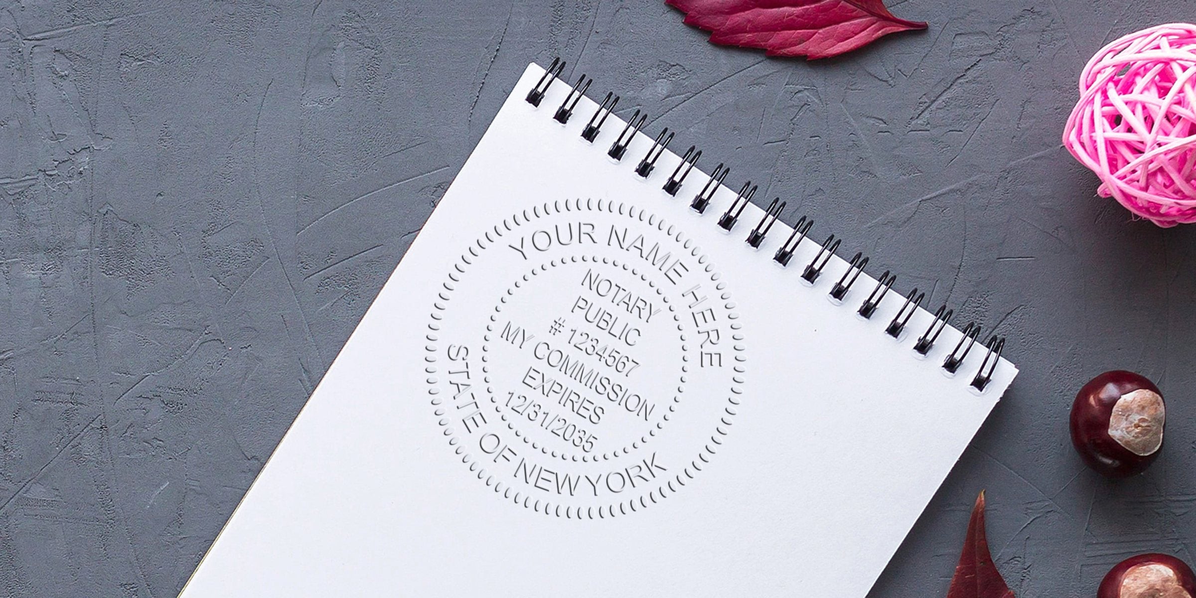 New York notary stamp on white spiral notebook, perfect for state commission verification and online notary stamp shopping.