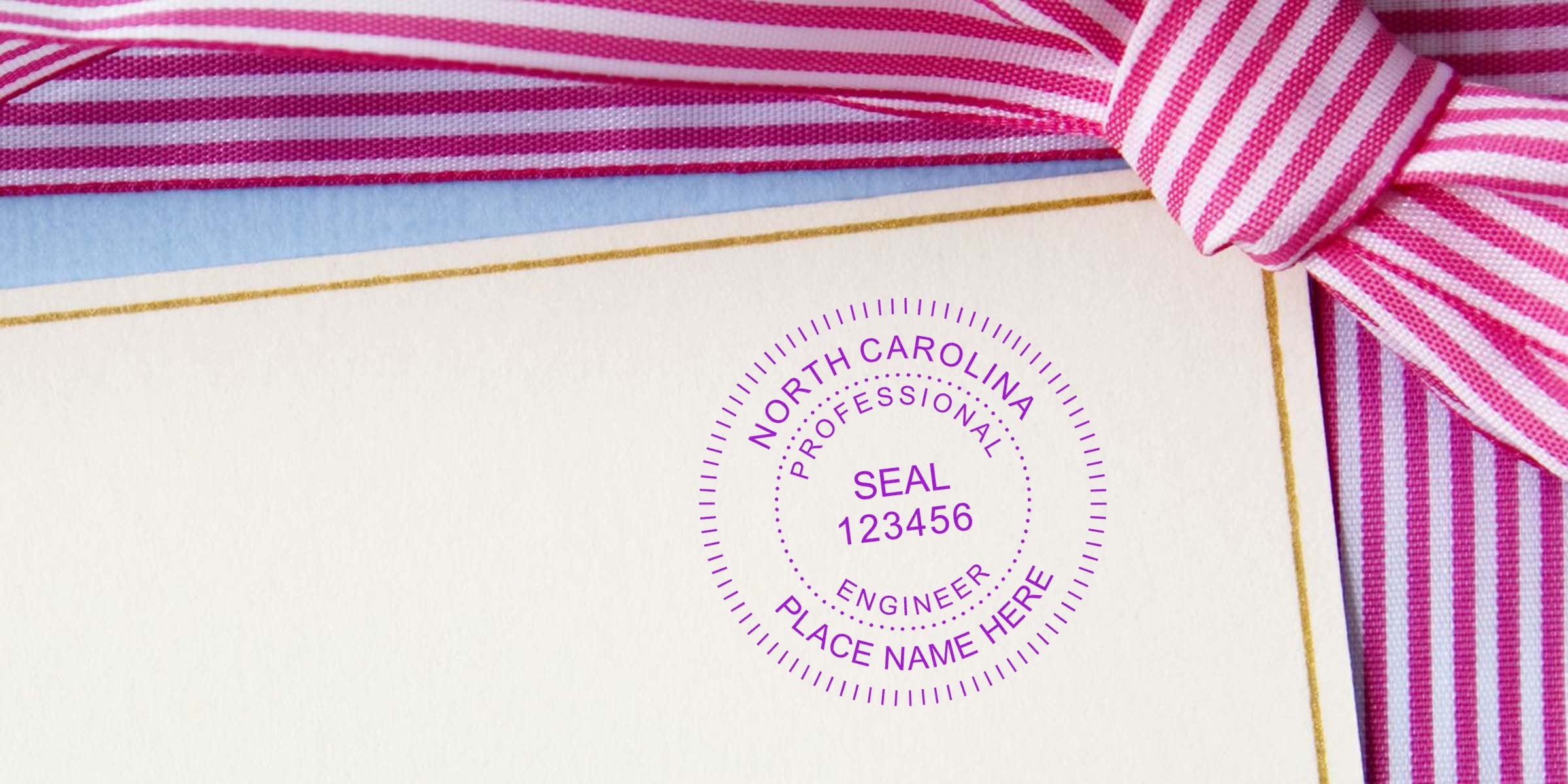 Buy PE Stamp NC for professional engineer seal on official documents with pink striped ribbon.