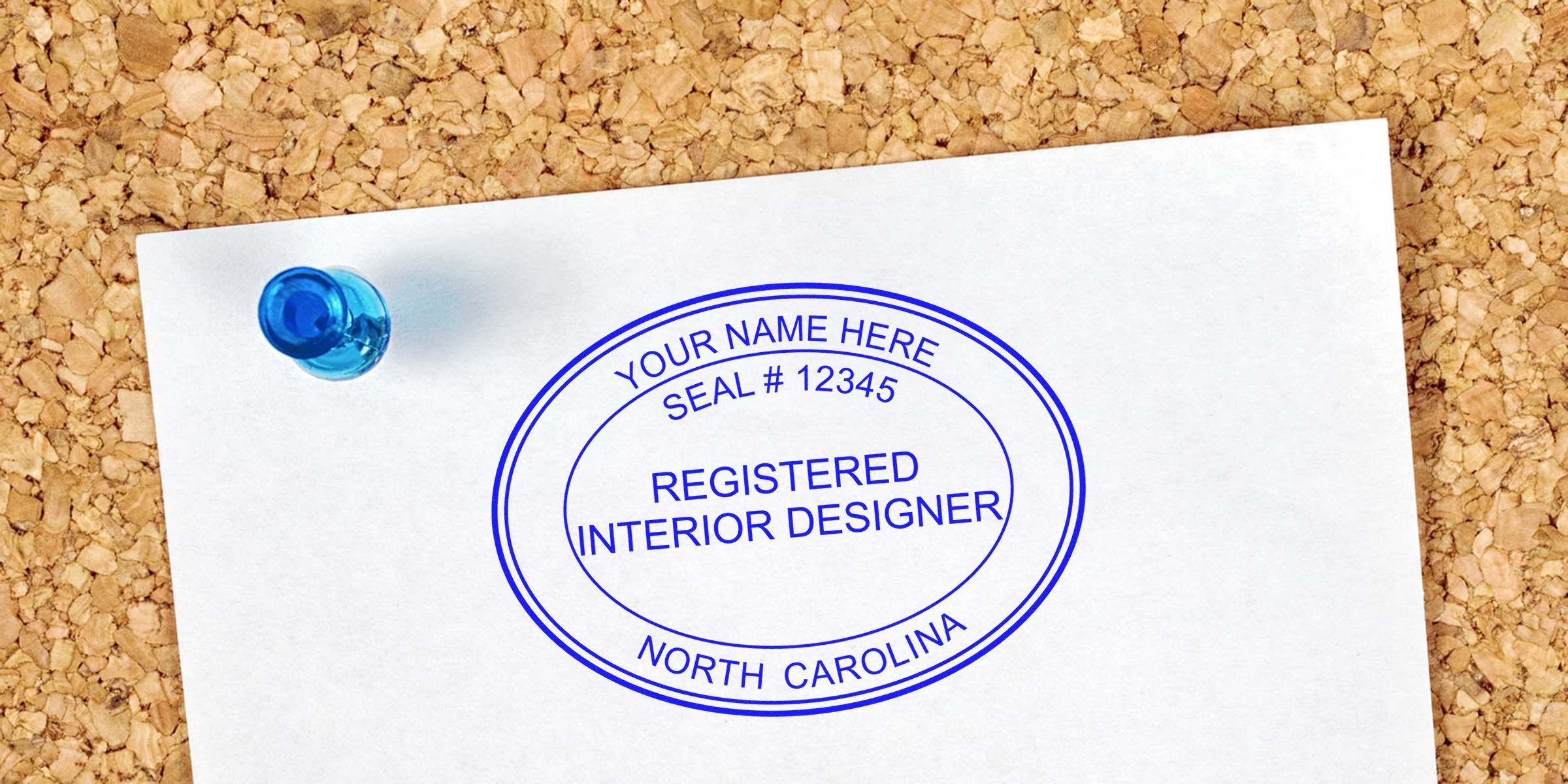 North Carolina interior designer’s stamp pinned on corkboard with a blue pushpin, displaying the stamp design guide.