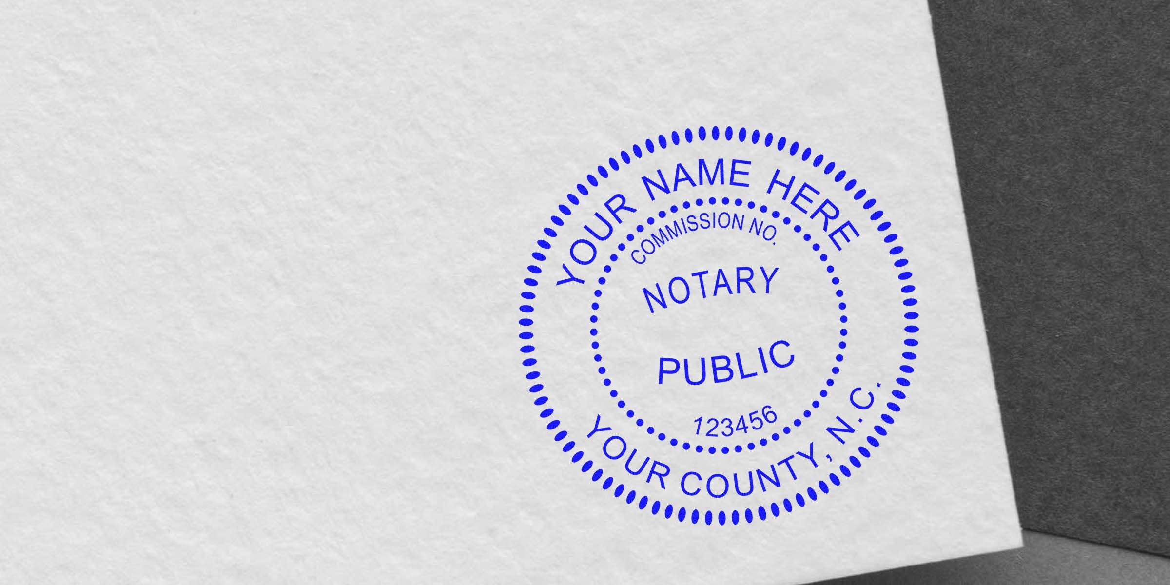 Blue notary stamp on white paper, vital North Carolina notary supplies for authenticating official documents, key NC notary essentials.