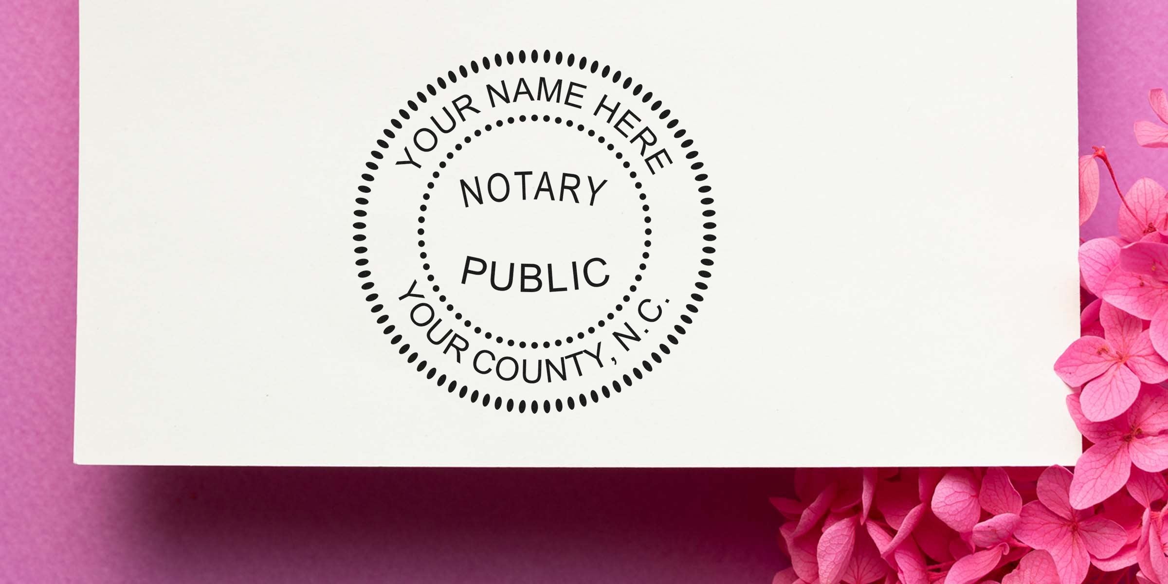 North Carolina notary stamp on white paper with pink flowers, official seal for legal documents, personalized for county certification, compliant with NC notary stamp guidelines.