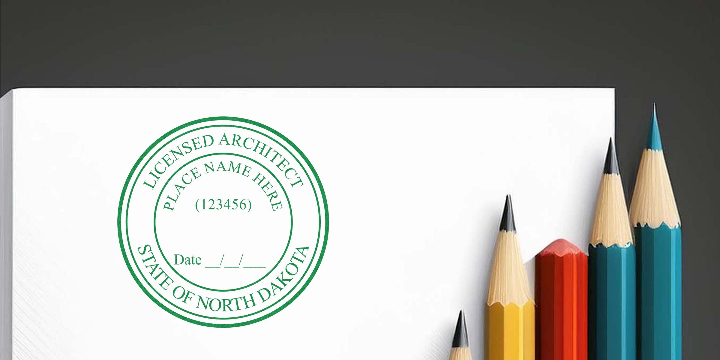Licensed architect stamp with North Dakota seal and colorful pencils on white paper, showcasing the benefits of the architect seal.