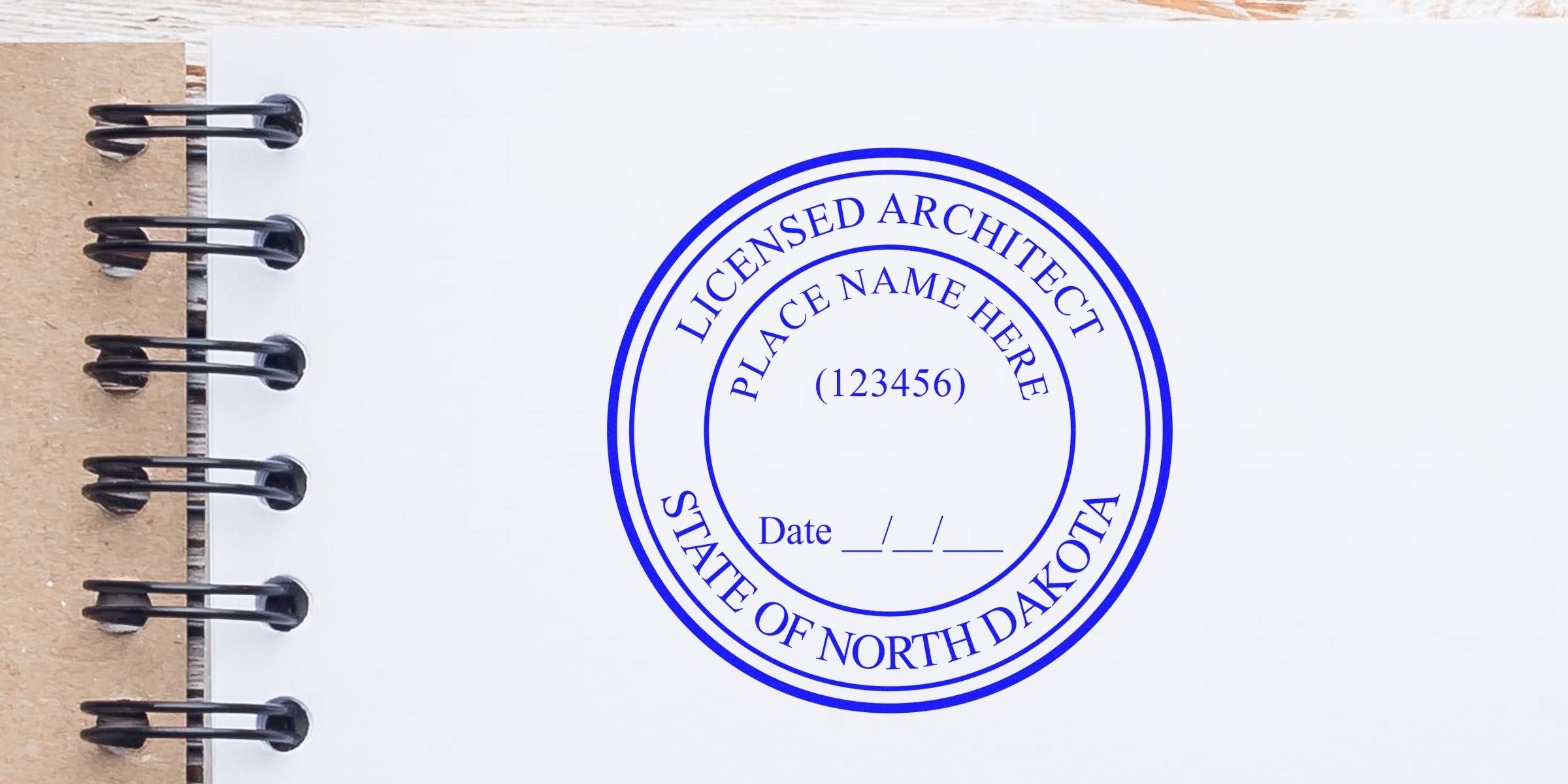 North Dakota architect seal embossed on a white spiral notebook page using an architect seal embosser.