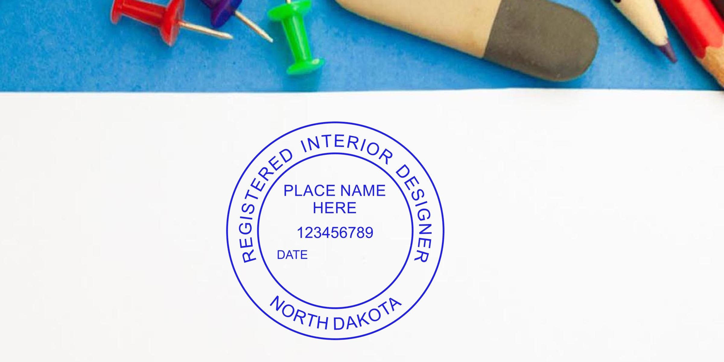 North Dakota registered interior designer seal with office supplies on blue background, showcasing North Dakota interior design and seal embossers.
