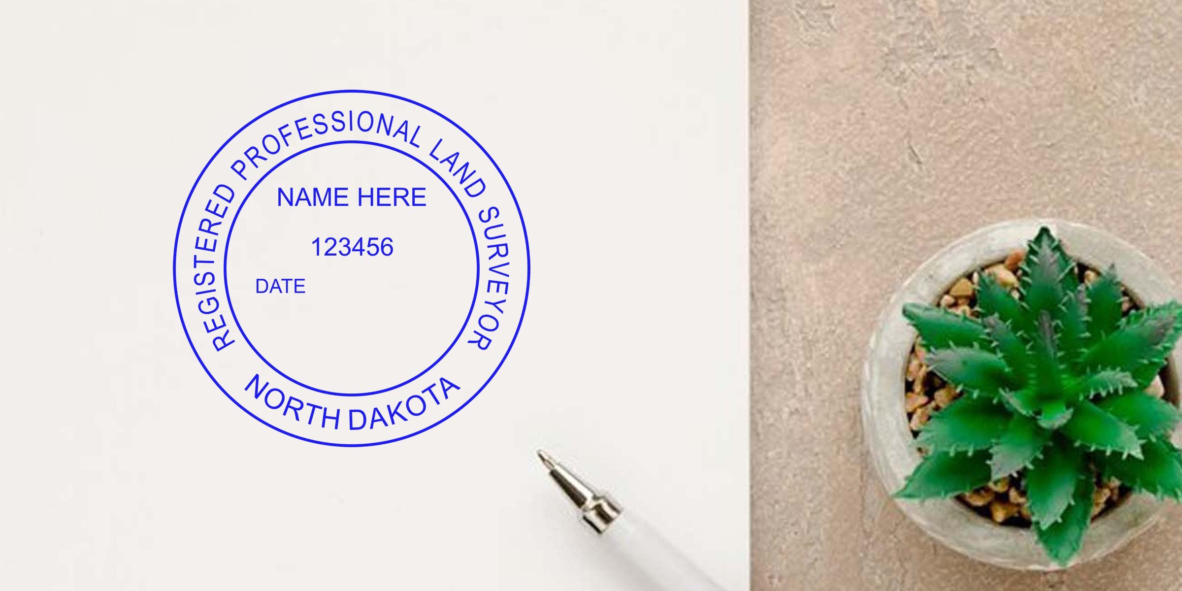 North Dakota land surveyor stamp on paper with pen and small green succulent, highlighting registered professional land surveyor and land surveyor requirements in North Dakota.