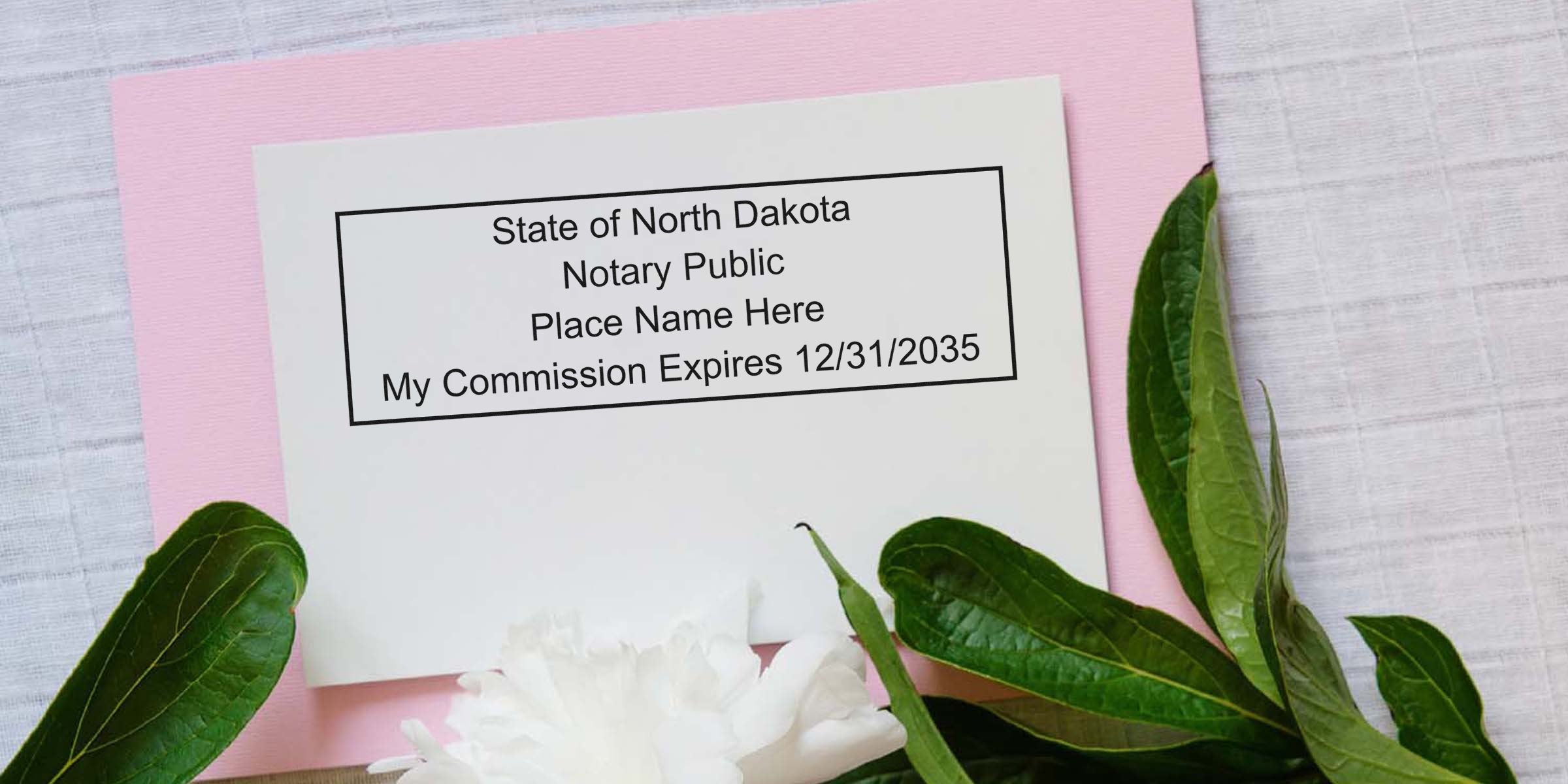 North Dakota notary commission certificate on white card with expiration date, framed by green leaves on pink background, showcasing North Dakota notary supplies and key items from the notary essentials list.