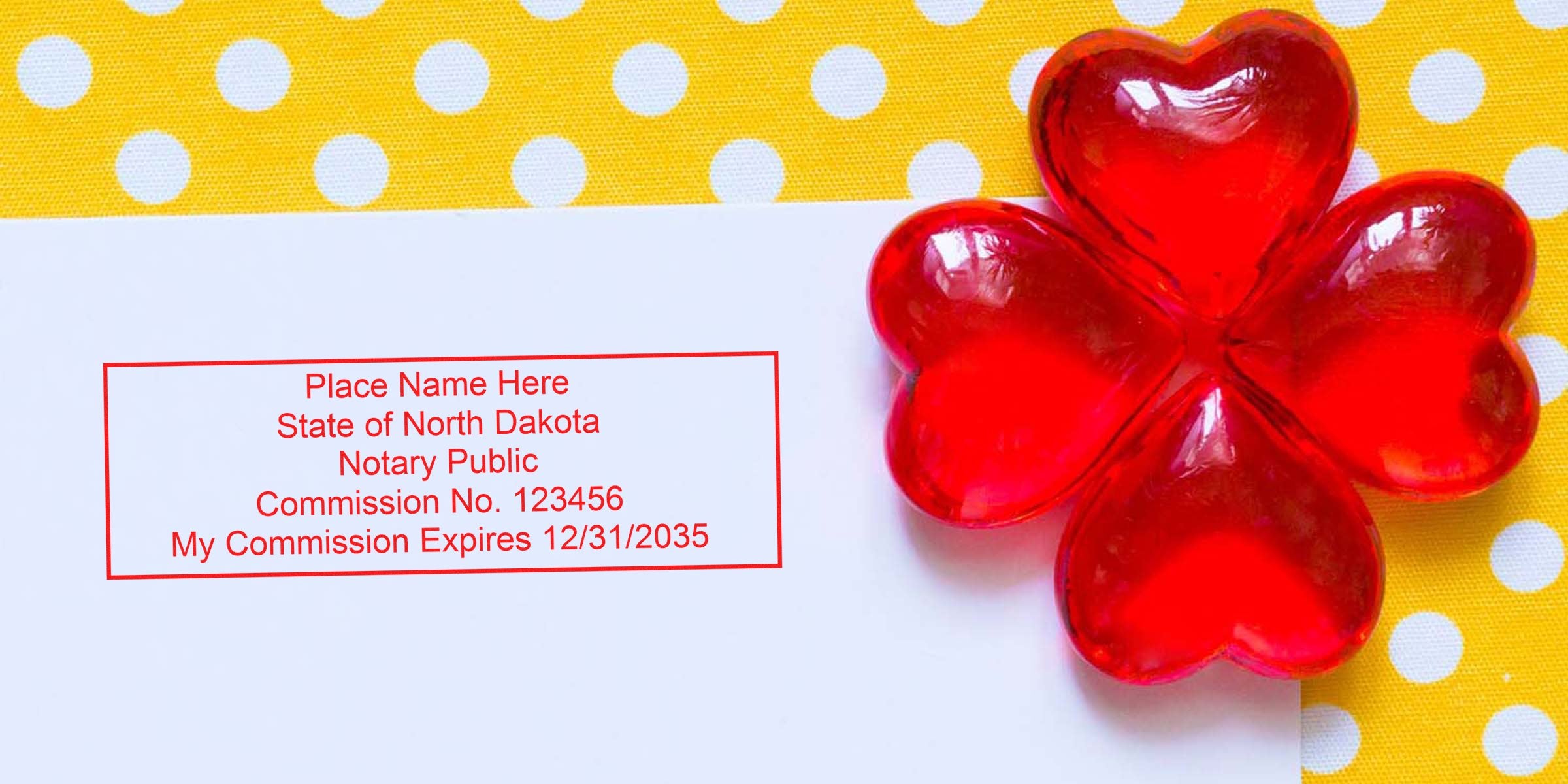 Red Notary Stamp North Dakota on white paper with heart-shaped red glass decorations on a yellow polka dot background, ideal for buying a Notary Stamp ND.