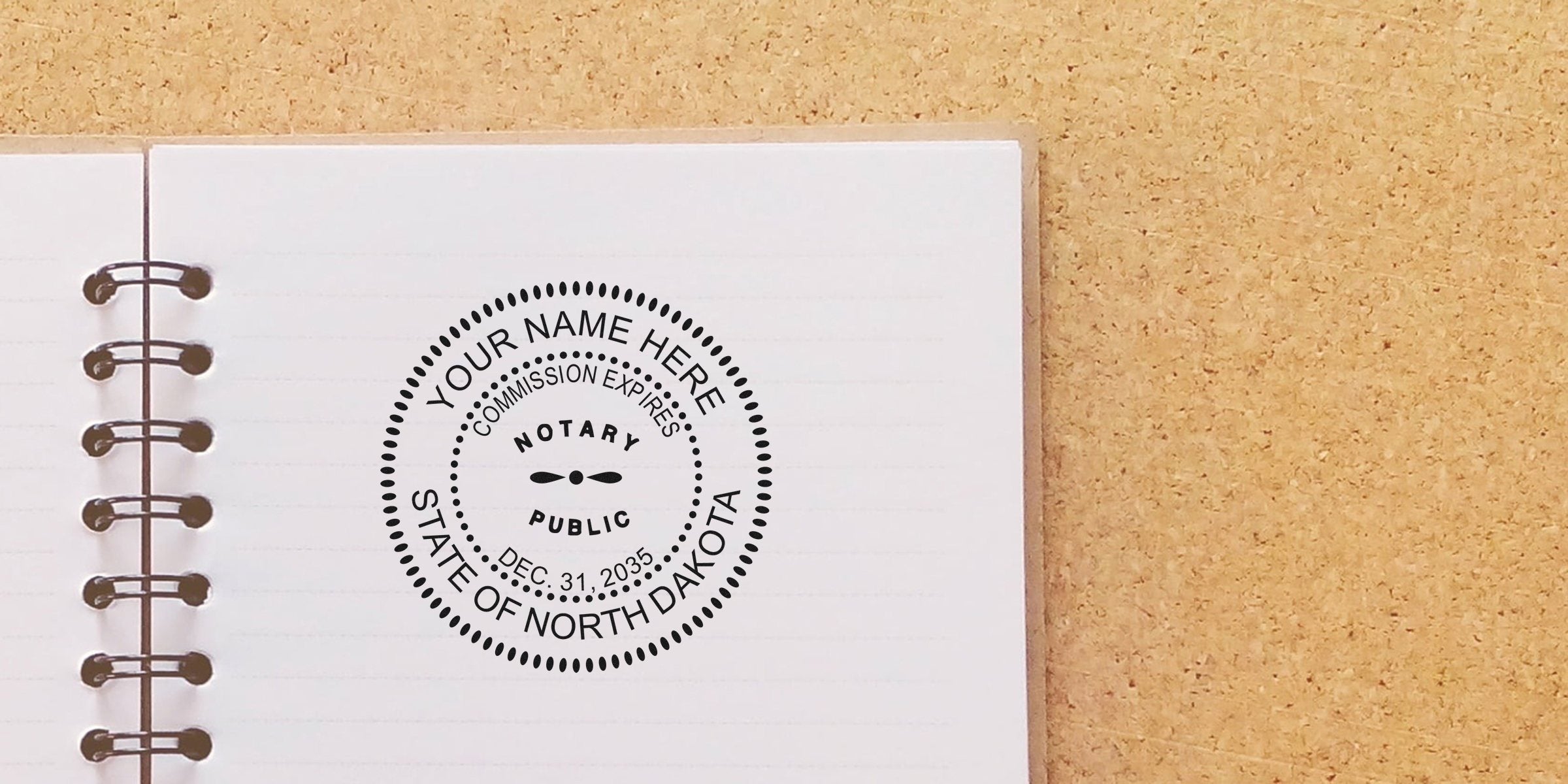 North Dakota notary stamp on notebook page displaying commission expiration date, meeting all notary stamp requirements.