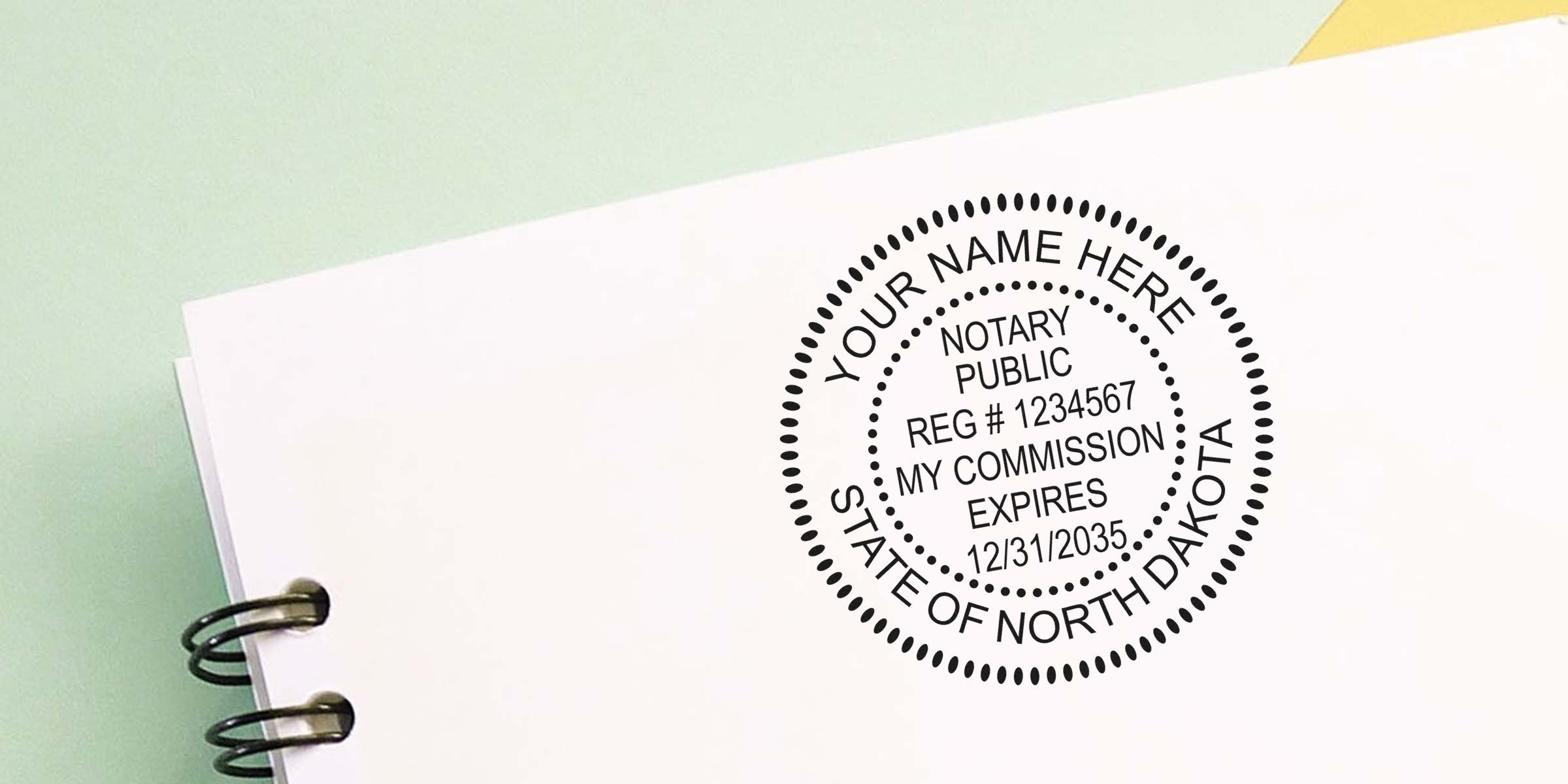 North Dakota notary stamp on white paper showing commission expiration date and registration number, applied with a self-inking stamp.