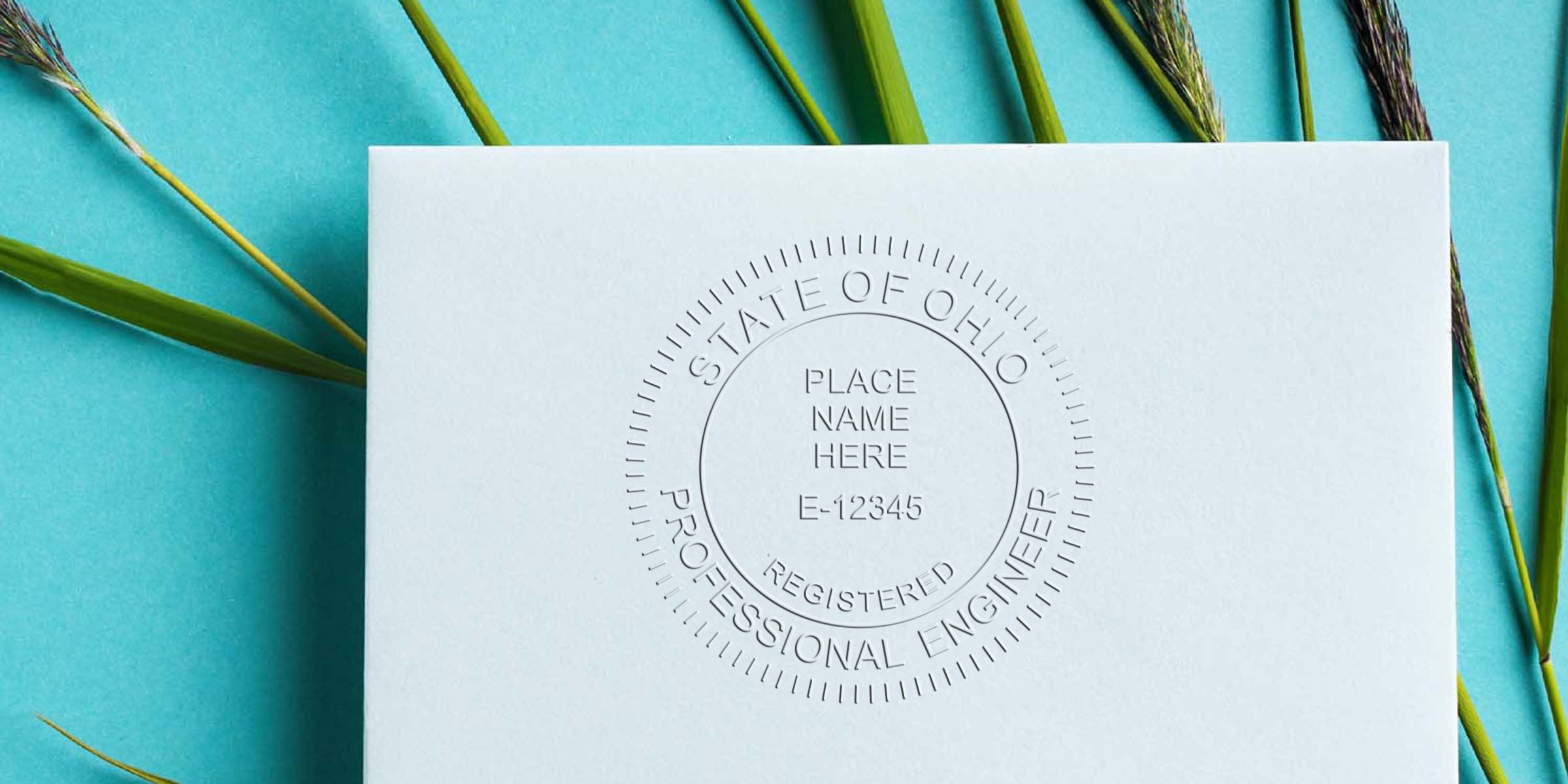 Ohio PE stamp embossed on white paper with green grass and blue background, showcasing self-inking stamp options.