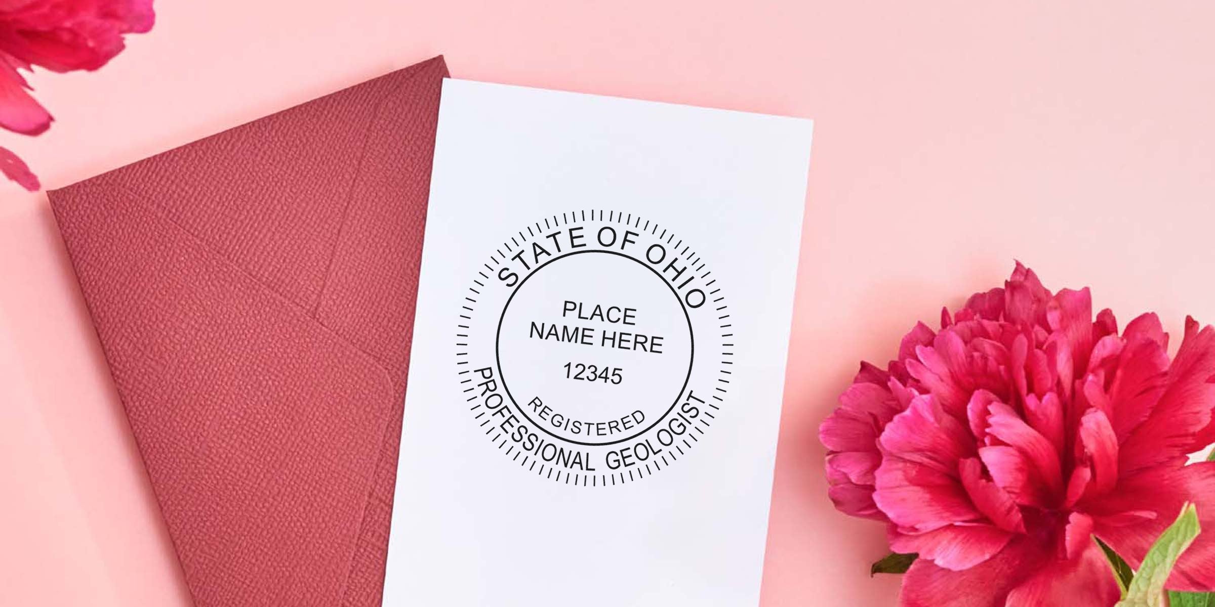 Ohio geologist stamp with professional seal on white card, paired with red envelope and pink flower background, highlighting the geologist stamp design.