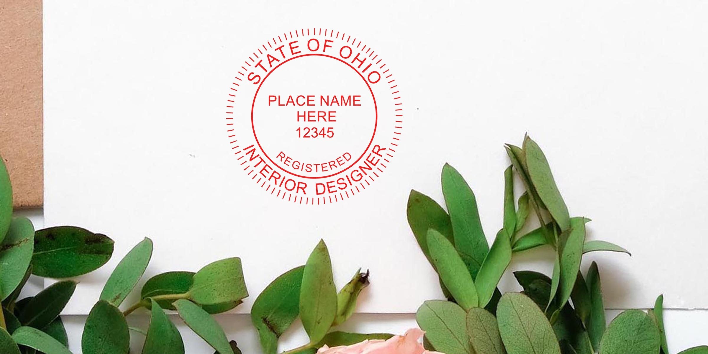 Ohio interior designer stamp on white paper with green leaves and a pink flower, showing the Ohio registered interior designer seal. Purchase interior designer stamps online.