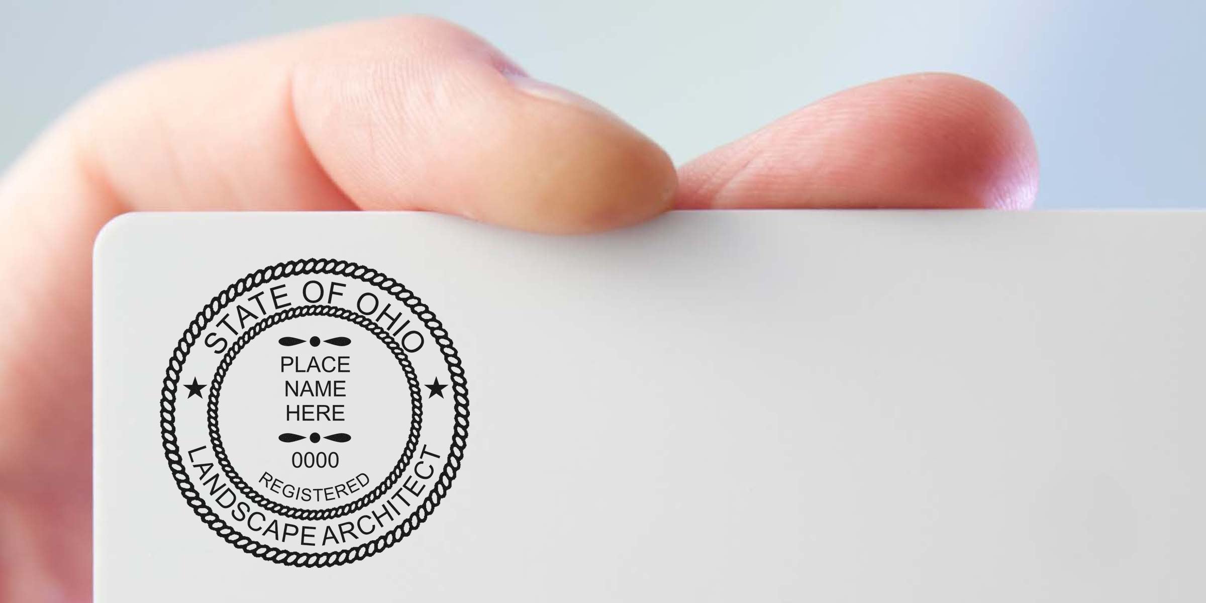 Hand holding Ohio landscape architect license card showing official state seal and registration details per seal guidelines.